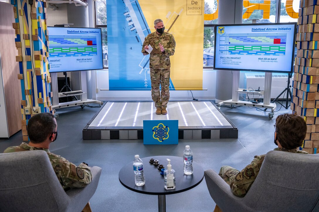 Col. Michael Peeler, 436th Operations Group commander, explains the stabilized aircrew initiative for Gen. Jacqueline Van Ovost, Air Mobility Command commander, and Chief Master Sgt. Brian Kruzelnick, AMC command chief, at Dover Air Force Base, Delaware, Dec. 9, 2020. The stabilized aircrew initiative allows airlift squadrons to better implement COVID-19 mitigation practices without sacrificing the flexibility needed for Rapid Global Mobility. (U.S. Air Force photo by Senior Airman Christopher Quail)