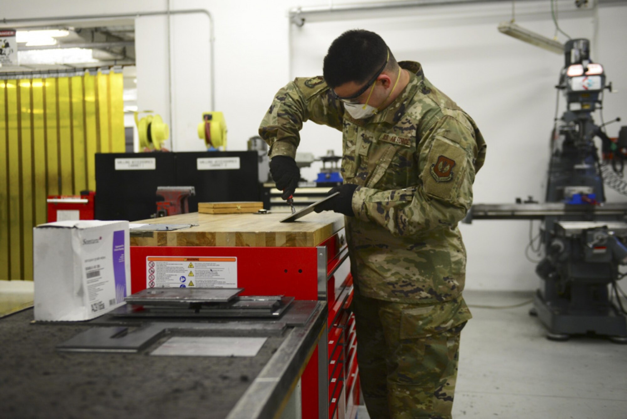Airman 1st Class Joshuah Fonteno, 31st Maintenance Squadron Aircraft Metals Technology Journeyman, stands and works at a bench at Aviano Air Base, Italy, Dec. 3, 2020. Fonteno stressed the importance of using extra time at home during COVID-19 to do away with negative habits and create positive ones. (U.S. Air Force photo by Tech. Sgt. Tory Cusimano)