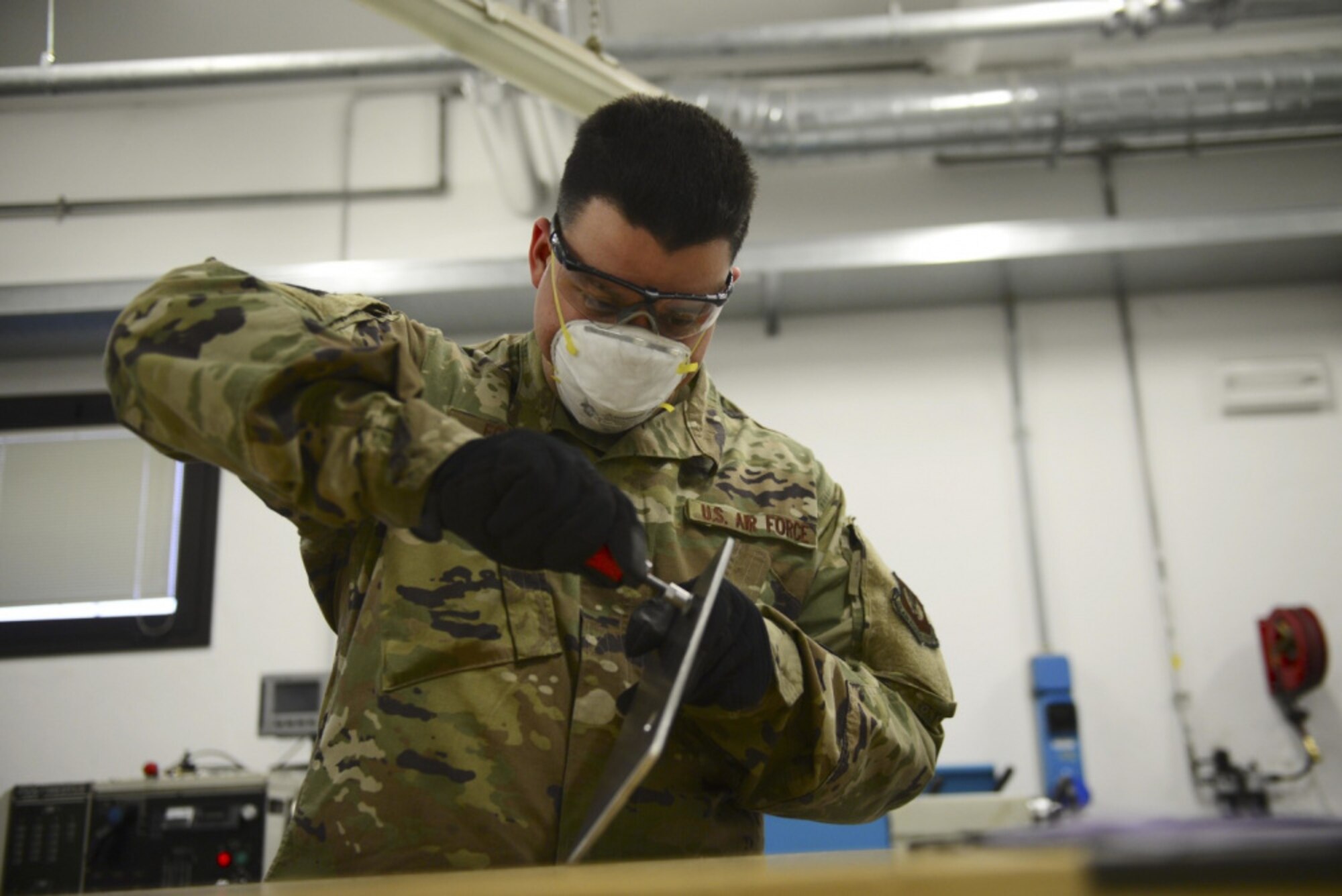 Airman 1st Class Joshuah Fonteno, 31st Maintenance Squadron Aircraft Metals Technology Journeyman, works on a piece of metal at Aviano Air Base, Italy, Dec. 3, 2020. Fonteno has used the extra time he's gained from COVID-19 conditions to improve himself by setting personal and professional goals. (U.S. Air Force photo by Tech. Sgt. Tory Cusimano)