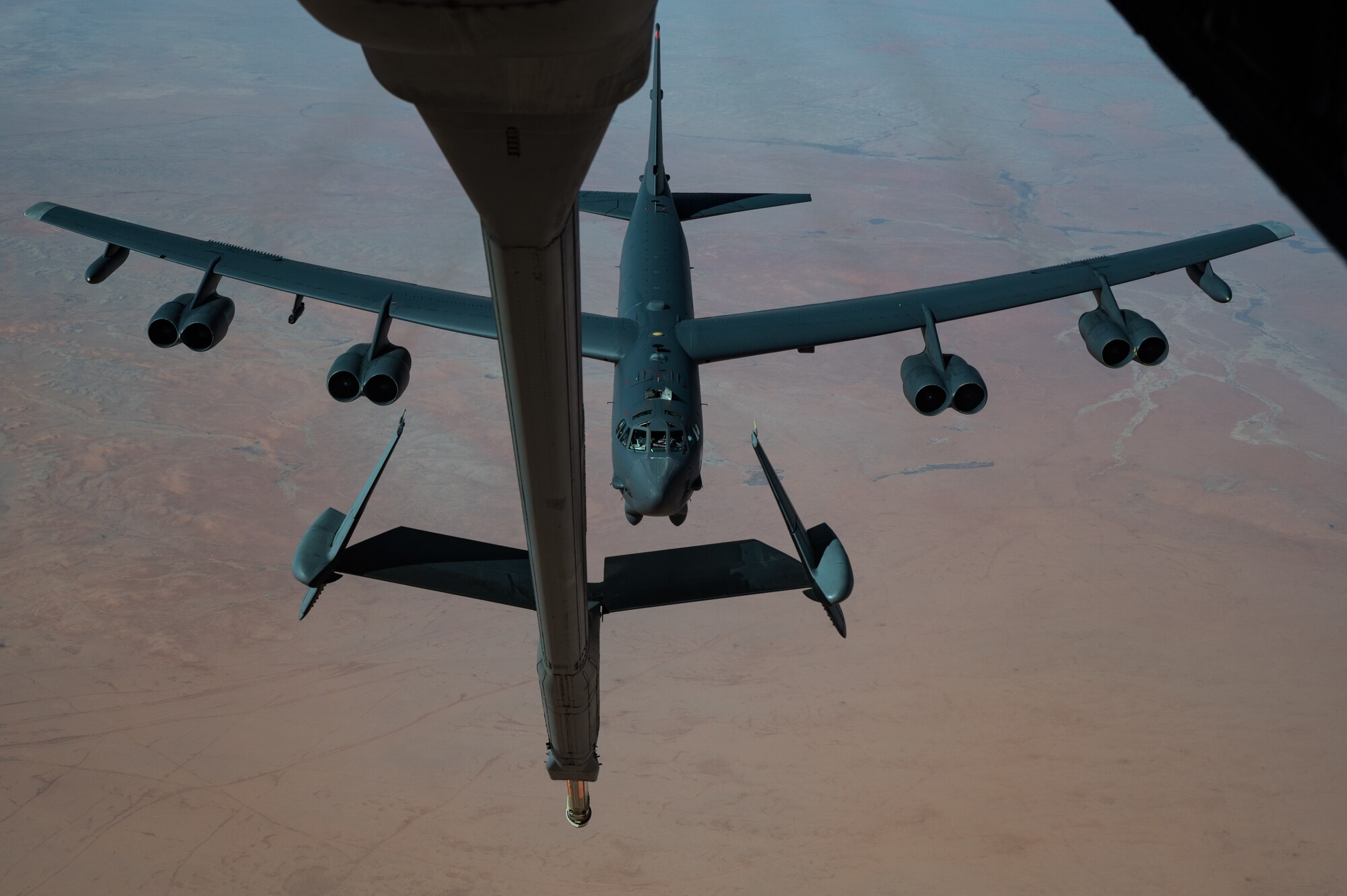 A U.S. Air Force B-52 Stratofortress pulls up behind a KC-10 Extender assigned to the 908th Expeditionary Air Refueling Squadron during an aerial refueling in the U.S. Central Command area of responsibility Dec. 10, 2020.  A pair of B-52s assigned to the Barksdale Air Force Base-headquartered 2nd Bomb Wing operated in the USCENTCOM area of responsibility with other U.S. Air Force and regional partner aircraft in the second mission in as many months. (U.S. Air Force photo by Staff Sgt. Sean Carnes)