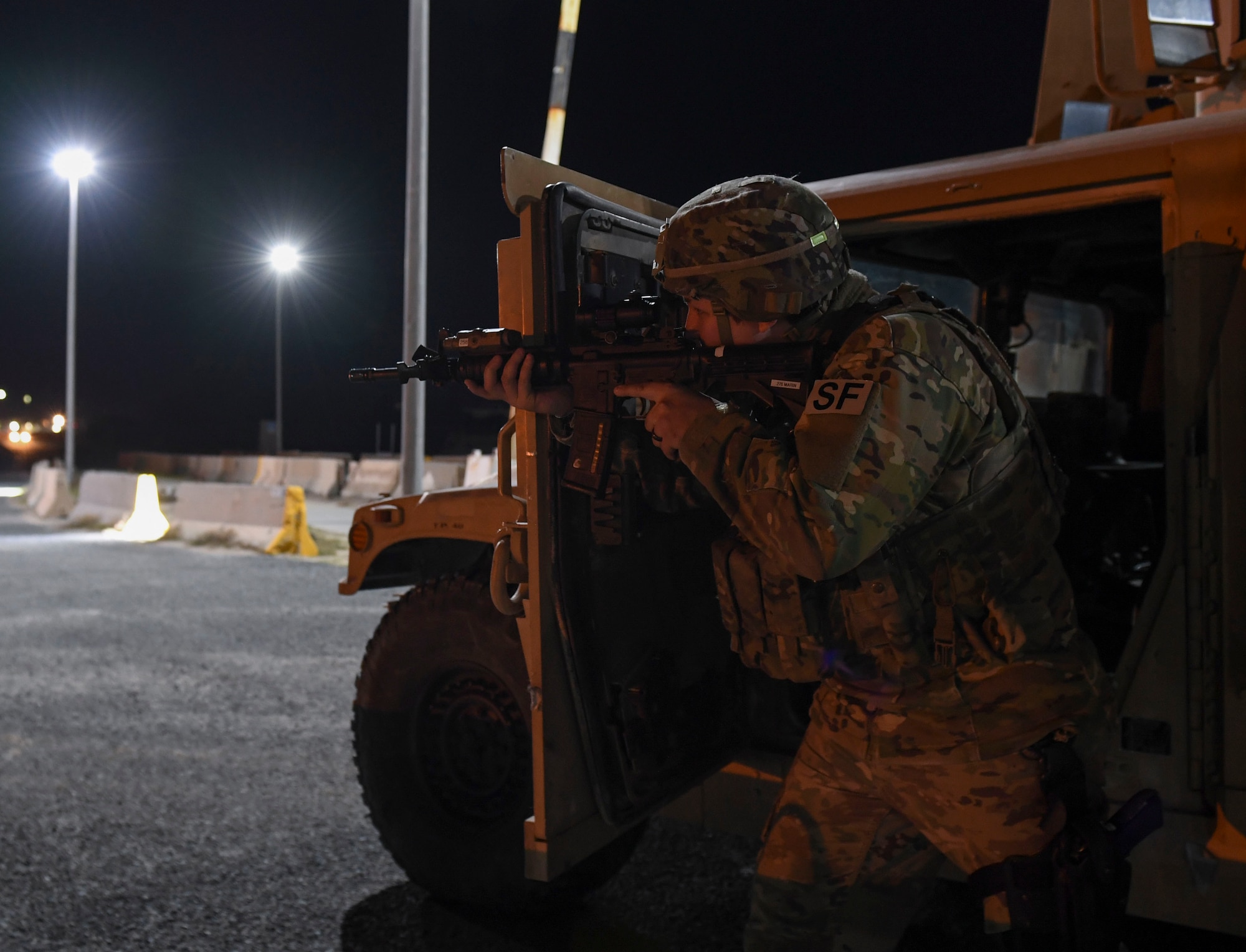 U.S. Air Force Staff Sgt. Karleigh Marin, 386th Expeditionary Security Forces Squadron response force leader, secures the area near an entry control point during the Marauder 21-02 exercise at Ali Al Salem Air Base, Kuwait, Dec. 8, 2020. The exercise tested unit responses to simulated attacks and increased elevation levels in the Force Protection Condition status. (U.S. Air Force photo by Senior Airman Monica Roybal)