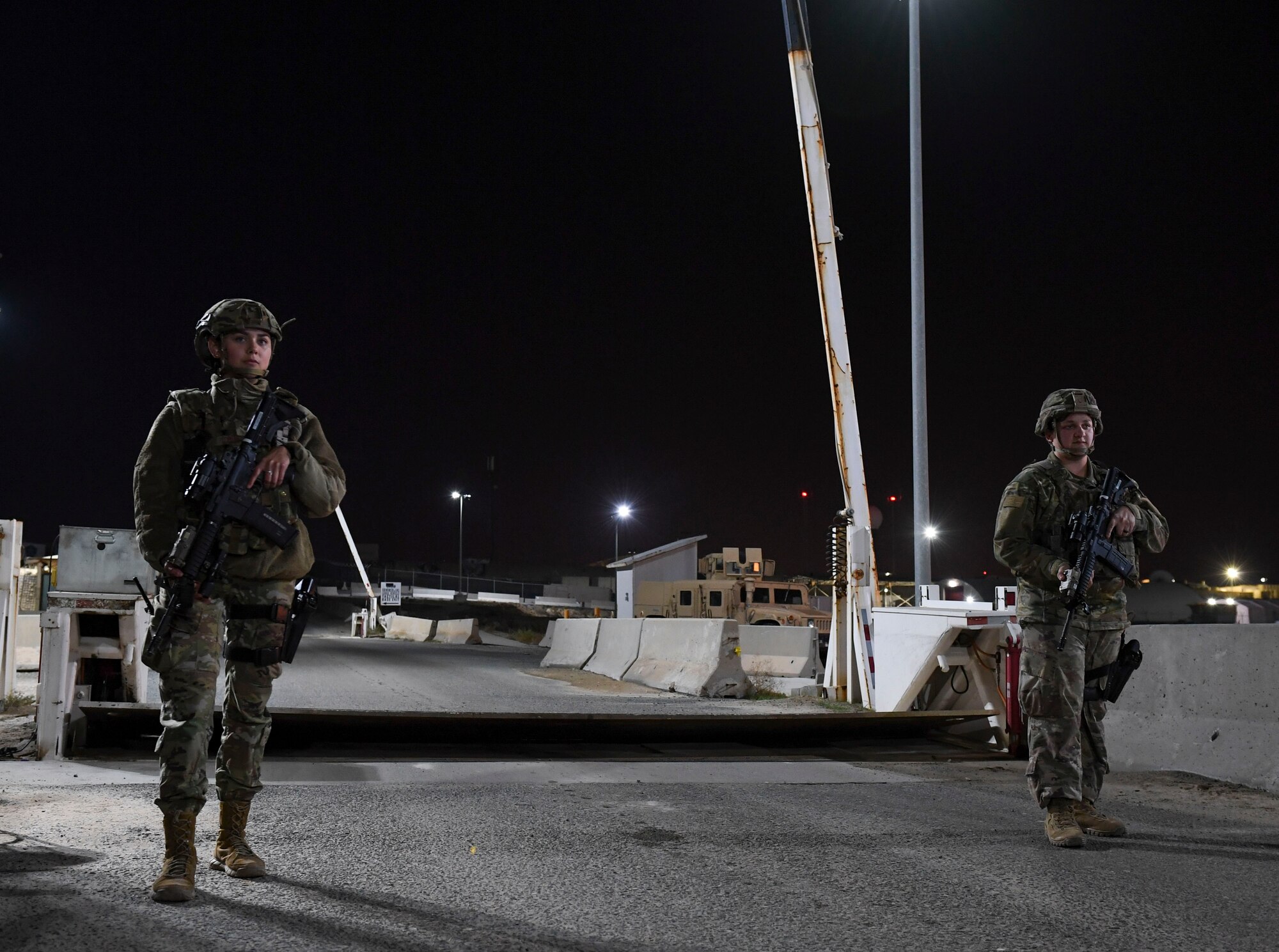 U.S. Air Force Airman 1st Class Miabella Contreras, 386th Expeditionary Security Forces Squadron response force member, and Staff Sgt. Karleigh Marin, 386th ESFS response force leader, guard an entry control point during the Marauder 21-02 exercise at Ali Al Salem Air Base, Kuwait, Dec. 8, 2020. 386th ESFS response teams were tasked with responding to simulated attacks and rapid Force Protection Condition level changes.  (U.S. Air Force photo by Senior Airman Monica Roybal)