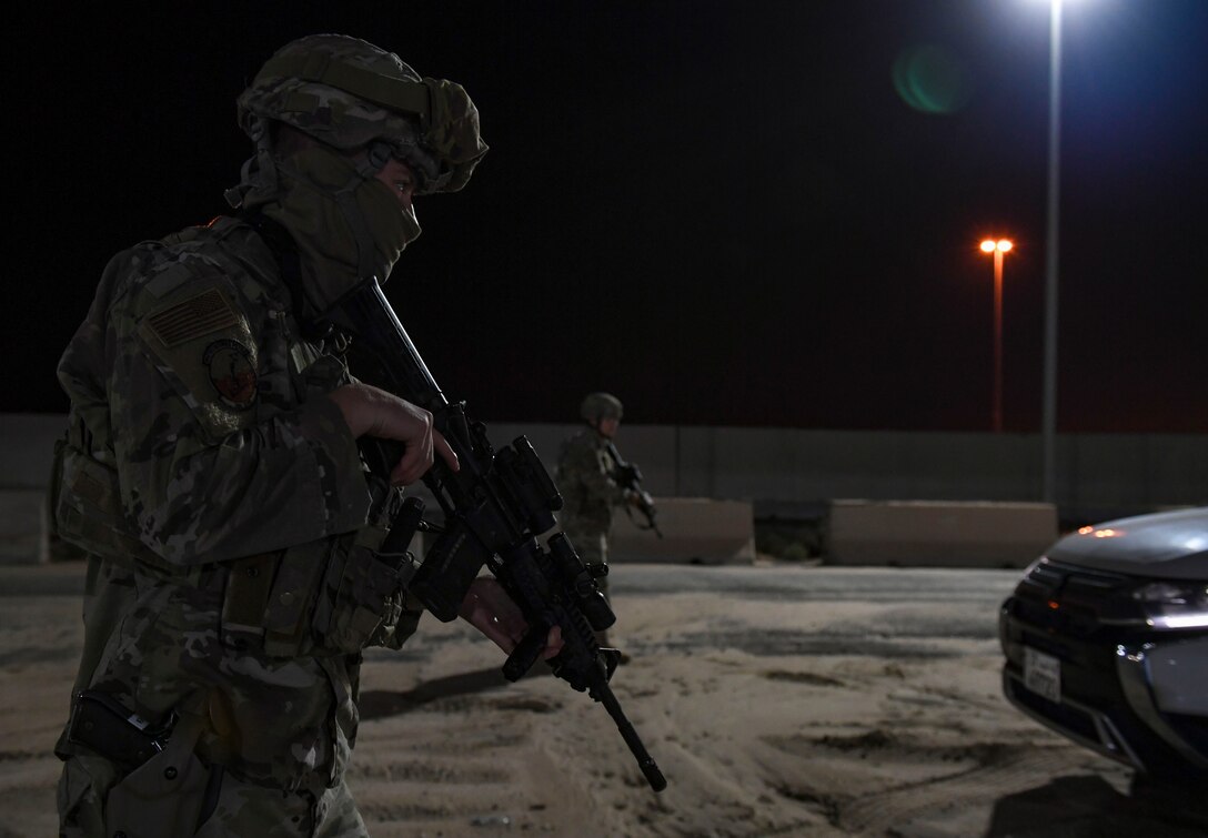 U.S. Air Force Senior Airmen Samuel Turley and Alberto Trinidad Marquez, 386th Expeditionary Security Forces Squadron response force leaders, approach a suspicious vehicle during the Marauder 21-02 exercise at Ali Al Salem Air Base, Kuwait, Dec. 8, 2020. The exercise aimed to test units’ response to elevated Force Protection Condition levels in shifting scenarios. (U.S. Air Force photo by Senior Airman Monica Roybal)