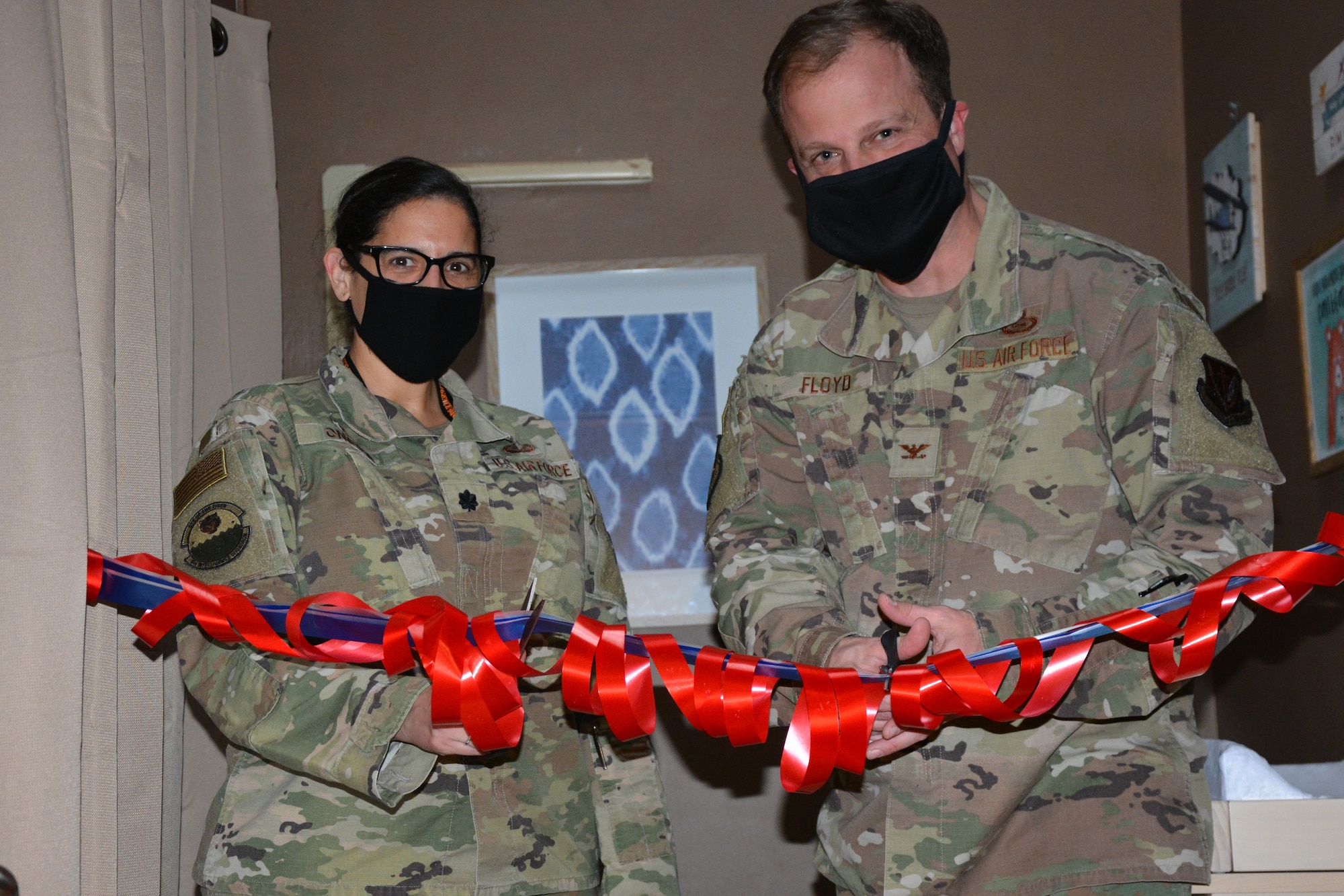 Lt. Col. Paola Ondina, 6th Intelligence Squadron commander, and Col. Gary Floyd, 694th Intelligence Surveillance and Reconnaissance Group commander, cut a ribbon in the 694th ISRG mother’s room  on Osan Air Force Base, Republic of Korea, November 12, 2020. The room is dedicated to the late Capt. Tranay Tanner, a previous 6th IS member who began the mother’s room project.  (U.S. Air Force courtesy photo)