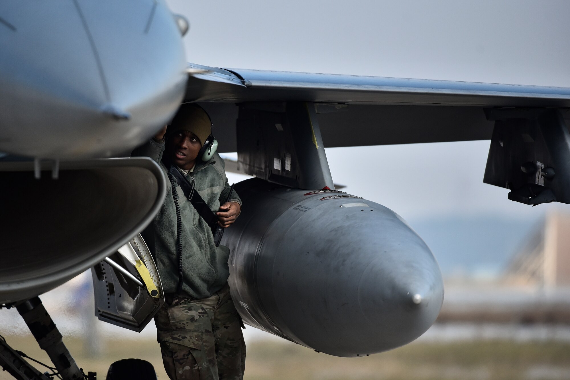 A weapons Airman performing a pre-flight inspection.