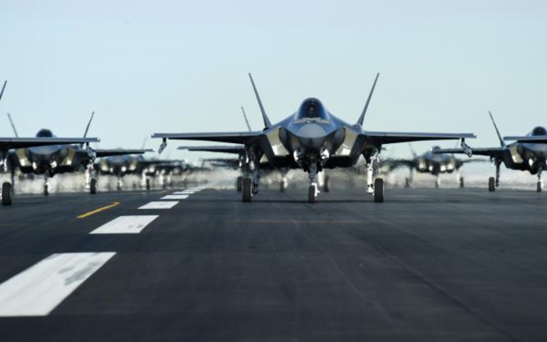 An F-35, prepped for flight sits on the runway.