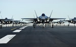 An F-35, prepped for flight sits on the runway.