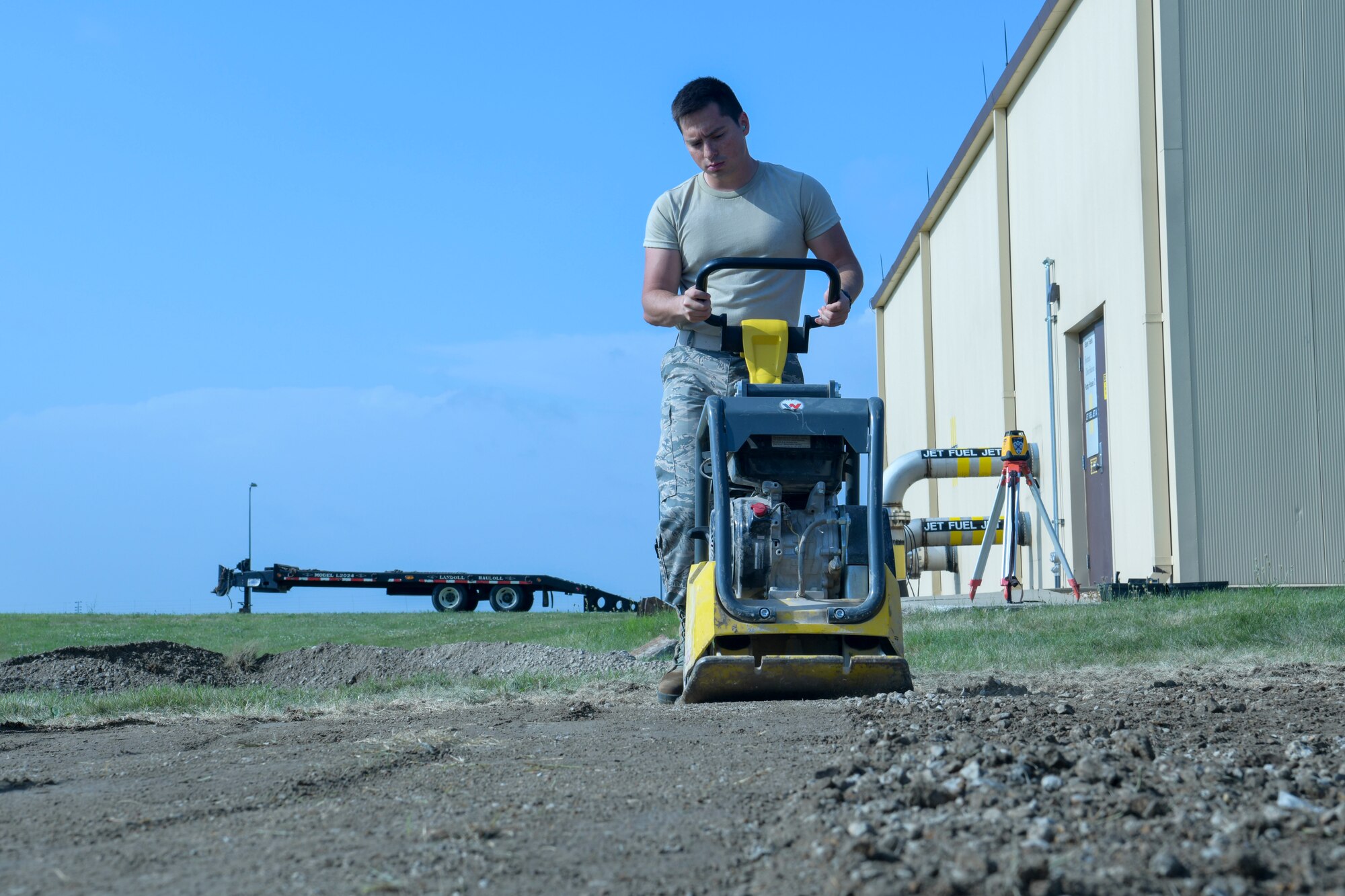 U.S. Air Force Airman 1st Class Jorge Morales-Corona, 509th Civil Engineer Squadron pavements and heavy equipment apprentice, compacts the ground with a tamper on a new construction project for a new generator at Whiteman Air Force Base, Missouri, June 3, 2020. Approximately 35 CES members from six different sections, took part in the troop training construction project.  (U.S. Air Force photo by Staff Sgt. Dylan Nuckolls)