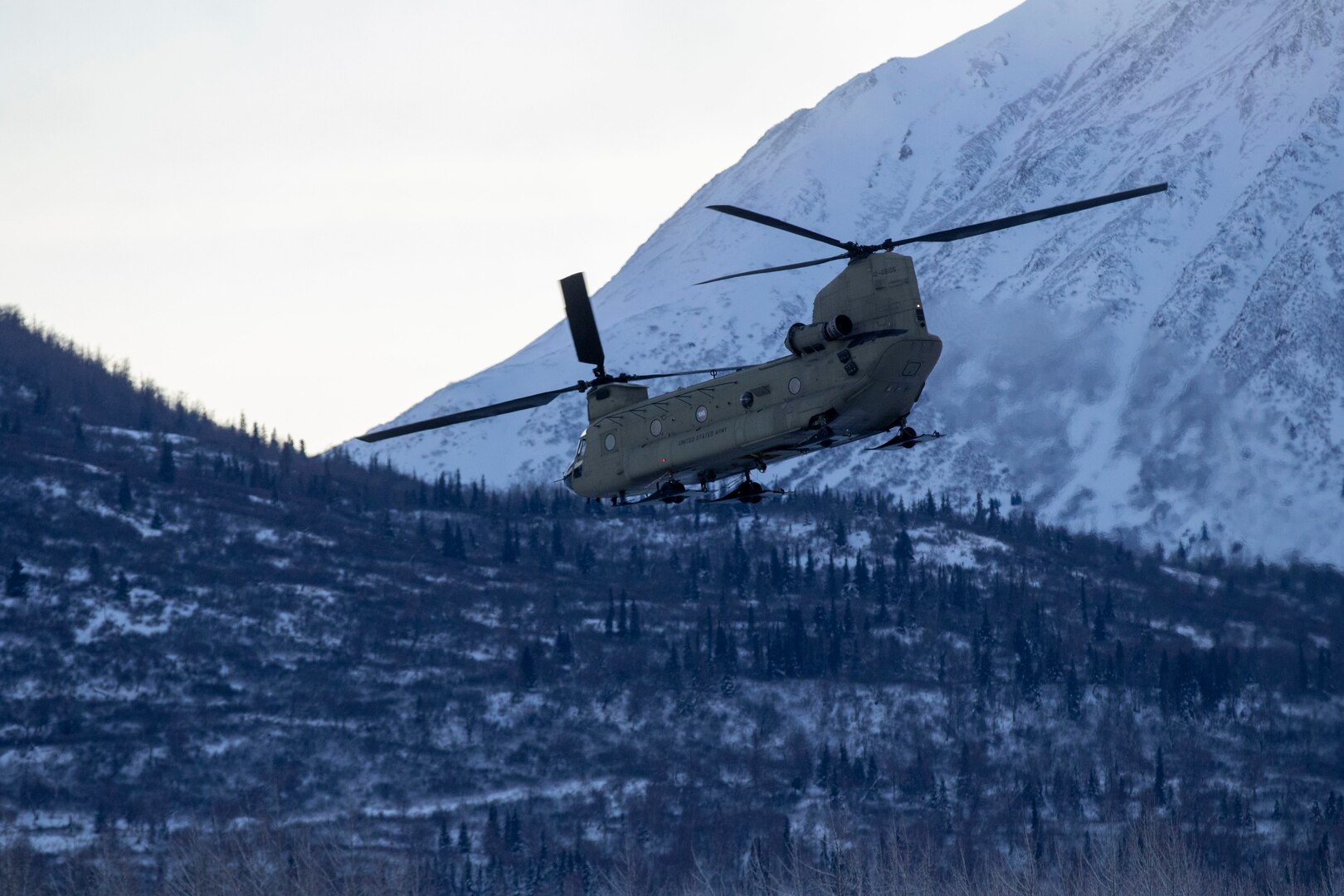 An Alaska Army National Guard Ch-47 Chinook helicopter departs Bryant Army Airfield Dec. 11 on it's way to Nanwalek to deliver Christmas gifts to the children of the village for Operation Santa Claus 2020.