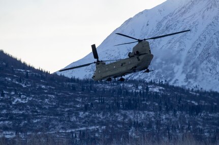 An Alaska Army National Guard Ch-47 Chinook helicopter departs Bryant Army Airfield Dec. 11 on it's way to Nanwalek to deliver Christmas gifts to the children of the village for Operation Santa Claus 2020.