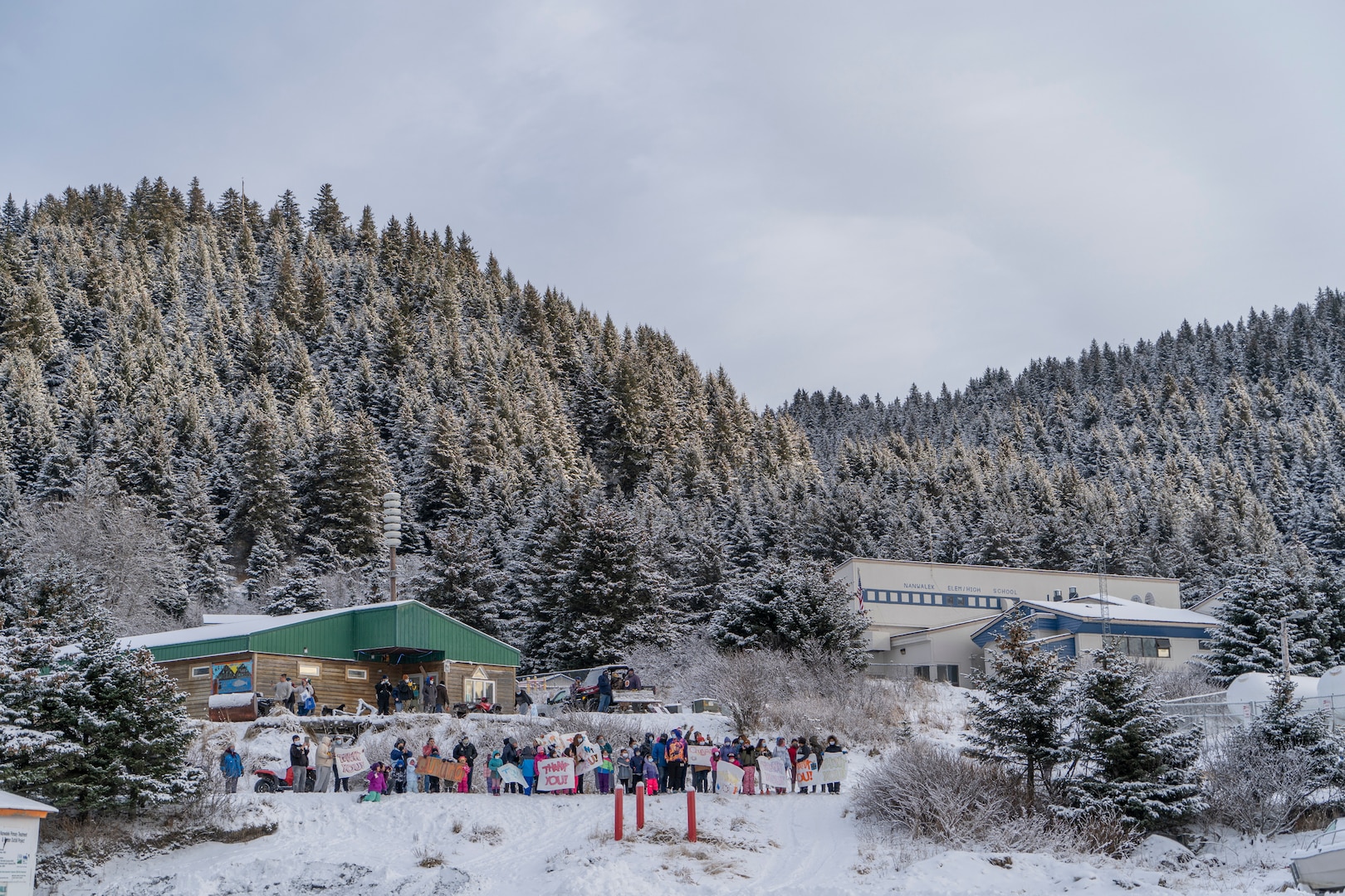 Residents of Nanwalek, Alaska, greet Guard members from the Alaska Army National Guard who delivered presents in a CH-47 Chinook helicopter from 1st Battalion, 207th Aviation Regiment, during Operation Santa, Dec. 11. This year marks the 65th year of the program.