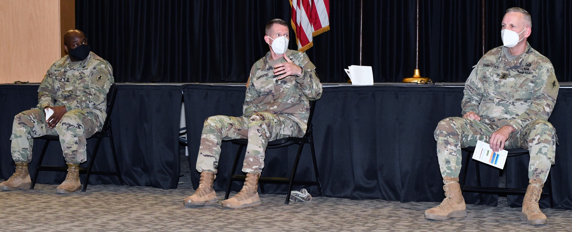 Command Sgt. Maj. Clark Charpentier (center) answers a question on the Army Combat Fitness Test as Sgt. Maj. Larry White II (left) and Maj. Gen. Dennis LeMaster (right) look on.