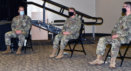 Col. Monica Douglas (center) shares her experiences with the Army Combat Fitness Test as Maj. Christopher Kahn and Lt. Col. Scott Scholfman look on.