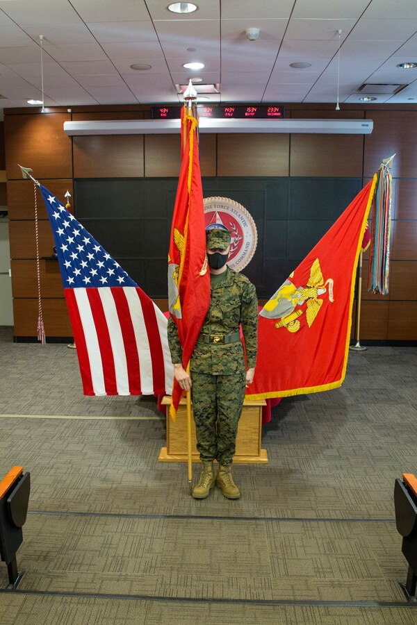 U.S. Marine Corps Cpl. Ryan Donnelly holds the U.S. Marine Corps Forces Northern Command (MARFORNORTH) colors during the transfer of authority ceremony between U.S. Marine Corps Forces Reserve and U.S. Marine Corps Forces Command, Fleet Marine Force Atlantic, at Naval Support Activity Hampton Roads, Norfolk, Virginia, Dec. 8, 2020. The transfer of MARFORNORTH roles and responsibilities will enhance the mission effectiveness of the naval forces assigned to U.S. Northern Command as they conduct their primary mission of Homeland Defense through more fully integrated staff processes, and additional opportunities for integration between Navy and Marine Corps counterparts. (U.S. Marine Corps Photo by Sgt. Danielle Prentice/Released)