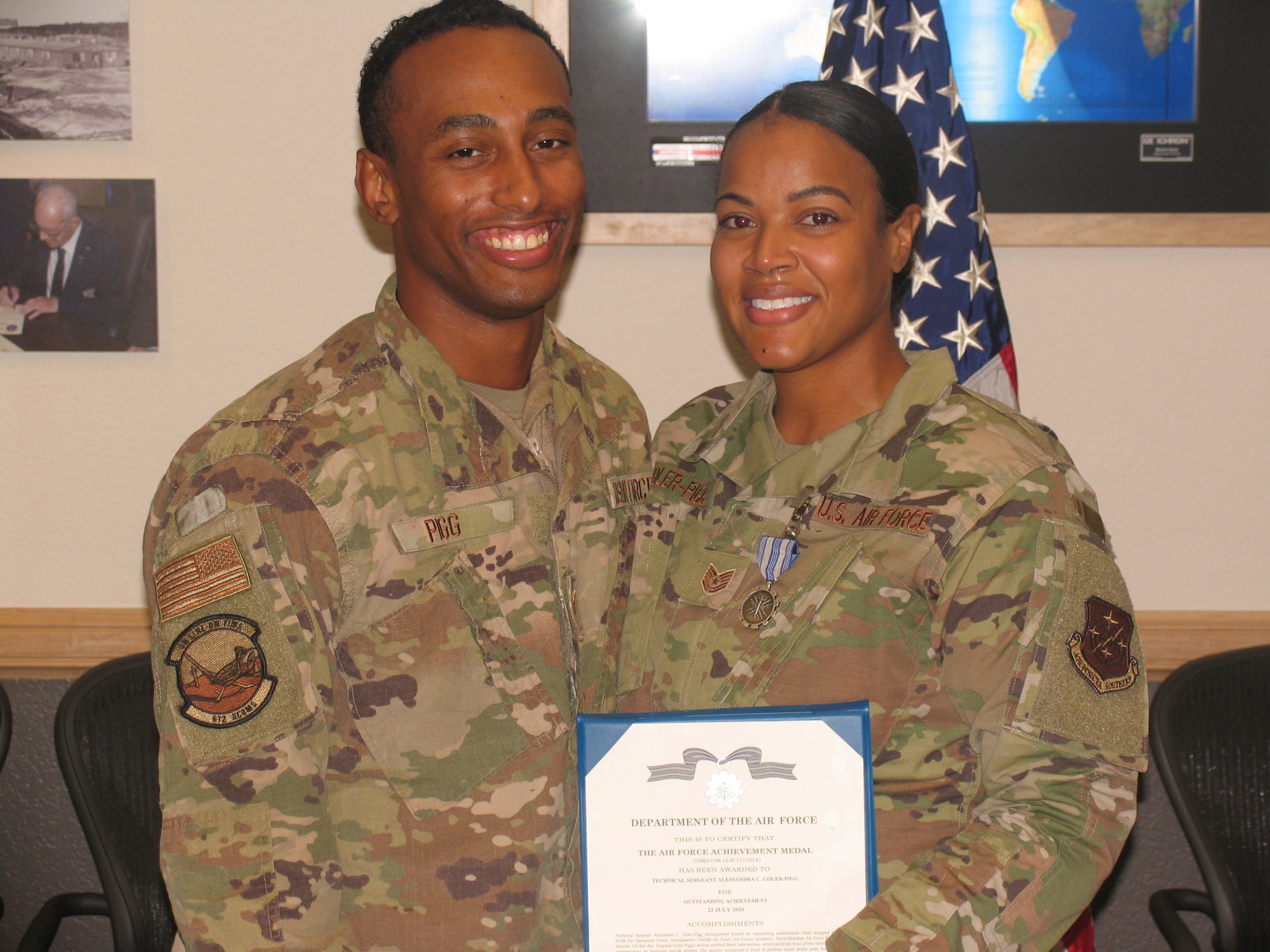 Picture of a man and woman holding up an award