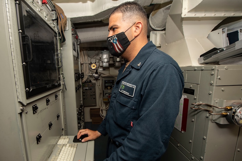 A person works on a router.