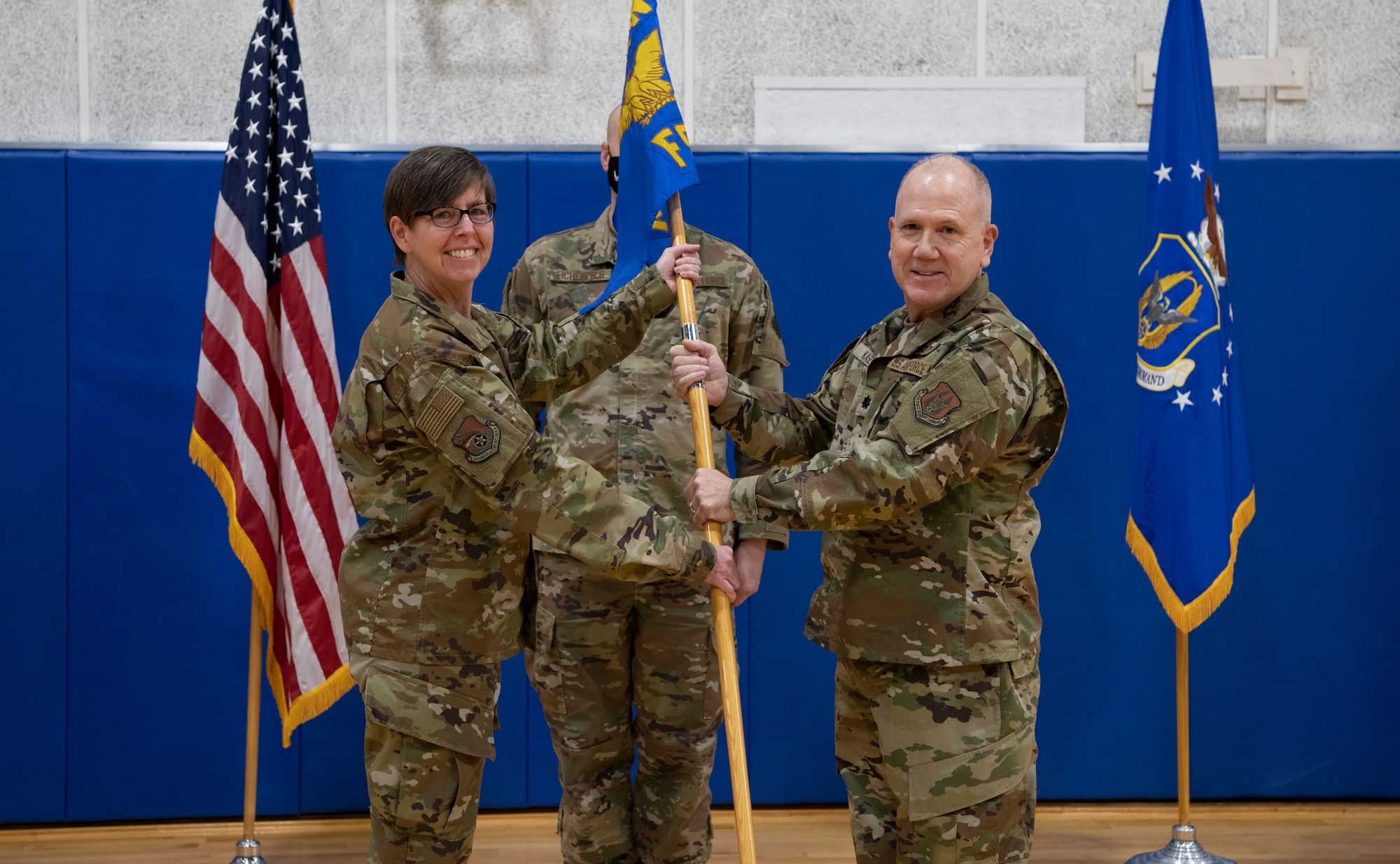 Col. Gretchen Wiltse, 434th Mission Support Group commander, passes the guidon to Lt. Col. Eric Kase, 434th Force Support Squadron commander, during an assumption of command ceremony at Grissom Air Reserve Base, Ind., Dec. 5, 2020. Kase assumed command of the 434th FSS from Lt. Col. Scott Uselding. (U.S. Air Force photo by Staff Sgt. Michael Hunsaker)