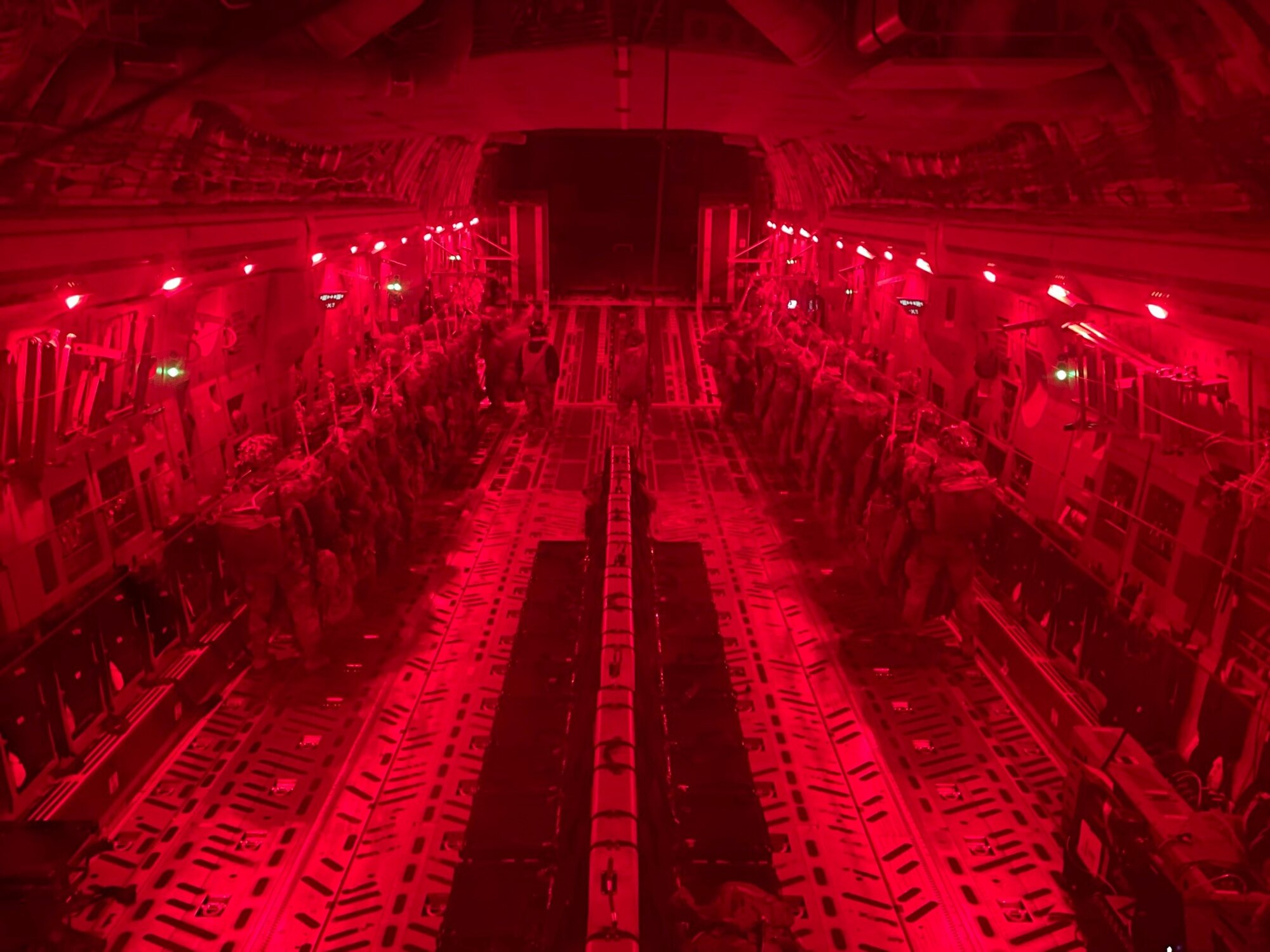 Paratroopers from the U.S. Army’s 82nd Airborne Division prepare to jump from a C-130 during a Battalion Mass Tactical Week training at Pope Army Airfield, N.C. Dec. 10, 2020.