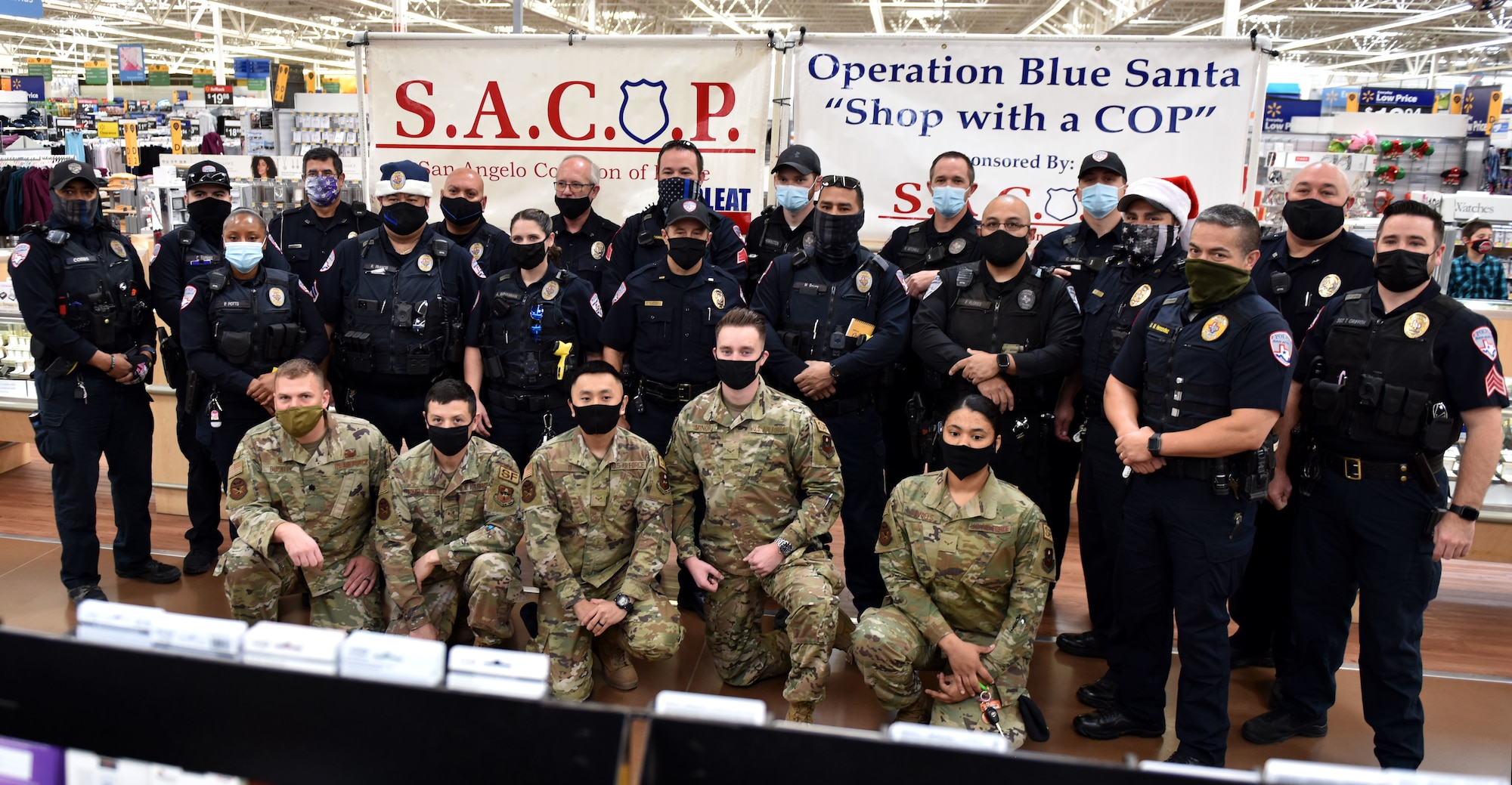 Police officers and Goodfellow members pose together before taking participants shopping at the 13th Annual Operation Blue Santa event in San Angelo, Texas, Dec. 12, 2020. This was the second year that Goodfellow members volunteered with local police officers for the event. (U.S. Air Force photo by Staff Sgt. Seraiah Wolf)