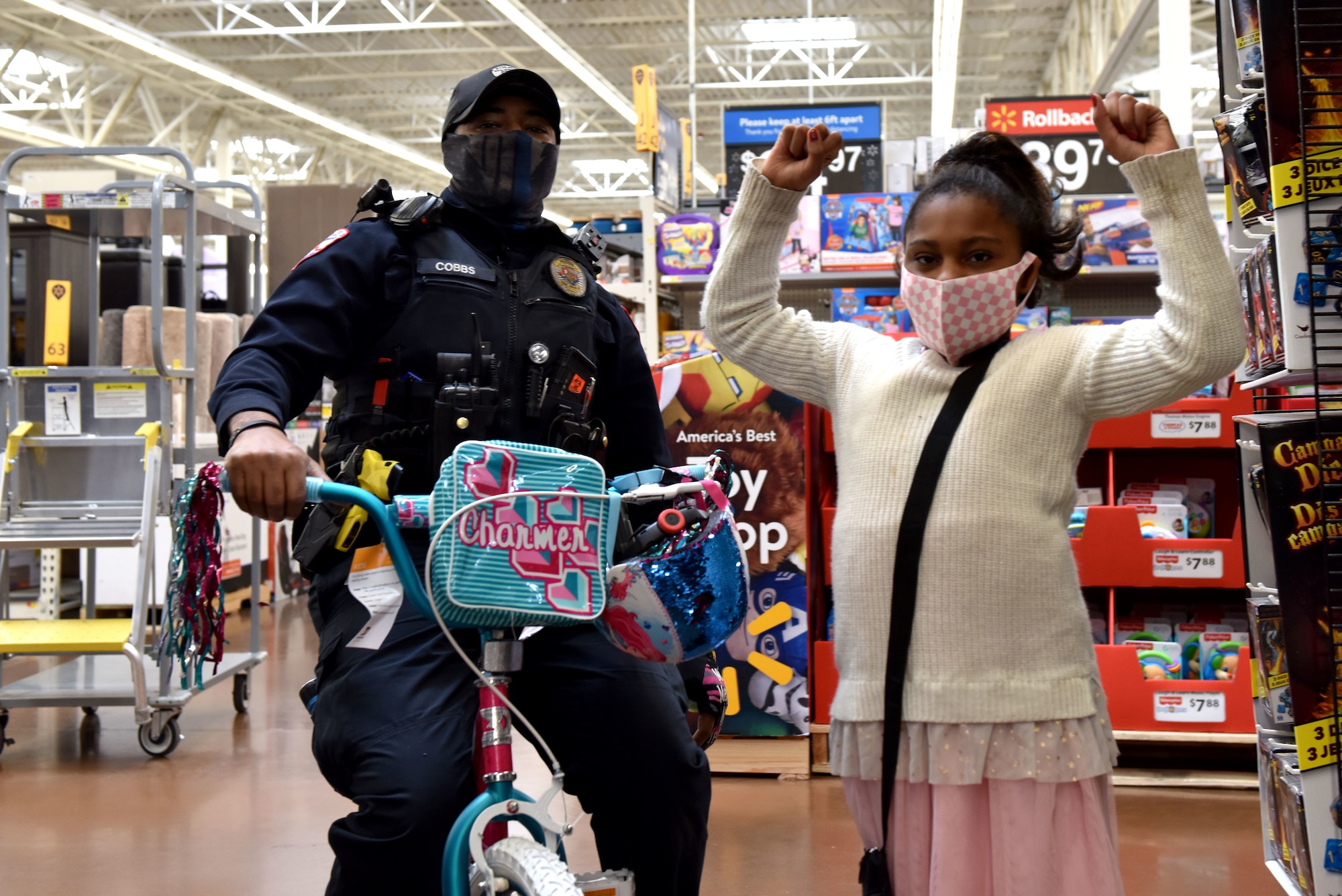 A San Angelo Police Officer tests out a bike that a participant in the 13th Annual Operation Blue Santa picked out as one of their gifts during the event in San Angelo, Texas, Dec. 12, 2020. Any child that picked out a bike also had to select a helmet for when they ride. (U.S. Air Force photo by Staff Sgt. Seraiah Wolf)