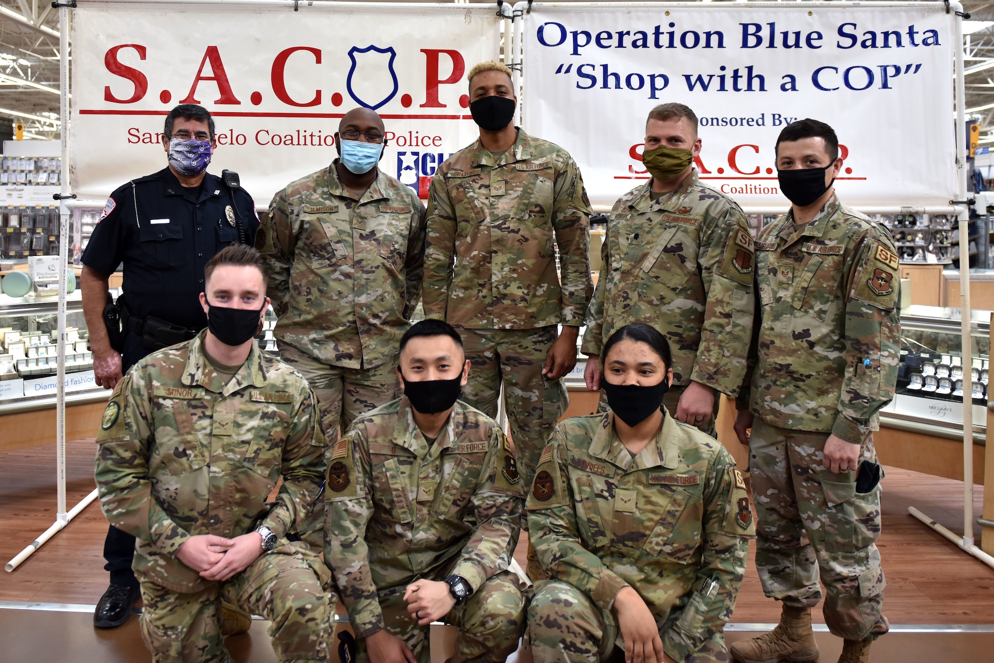 A San Angelo Police Officer poses with volunteers from the 17th Security Forces Squadron at the 13th Annual Operation Blue Santa event in San Angelo, Texas, Dec. 12, 2020. This is the second year that Goodfellow members participated in the event. (U.S. Air Force photo by Staff Sgt. Seraiah Wolf)