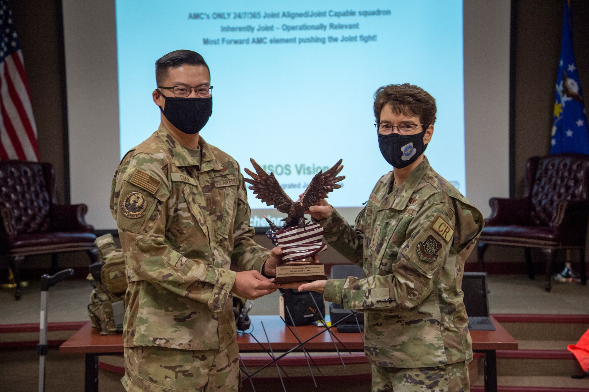 Capt. David Chan, 621st Mobility Support Opera-tions Squadron Air Mobility Liaison Officer, re-ceives Air Mobility Command’s 2019 Company Grade Officer of the Year award from Gen. Jacqueline Van Ovost, AMC commander, Dec. 11, 2020, at Joint Base McGuire-Dix-Lakehurst, New Jersey. During the visit, Van Ovost and Chief Master Sgt. Brian Kruzelnick, AMC command chief, experienced firsthand how the 621st Contin-gency Response Wing supports AMC’s priorities of developing the force, advancing warfighting capabilities, projecting the joint force and ensuring strategic deterrence. (U.S. Air Force illustration by Staff Sgt. Sarah Brice)