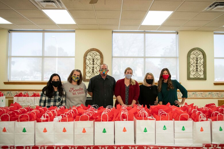 People stand in front of bags.