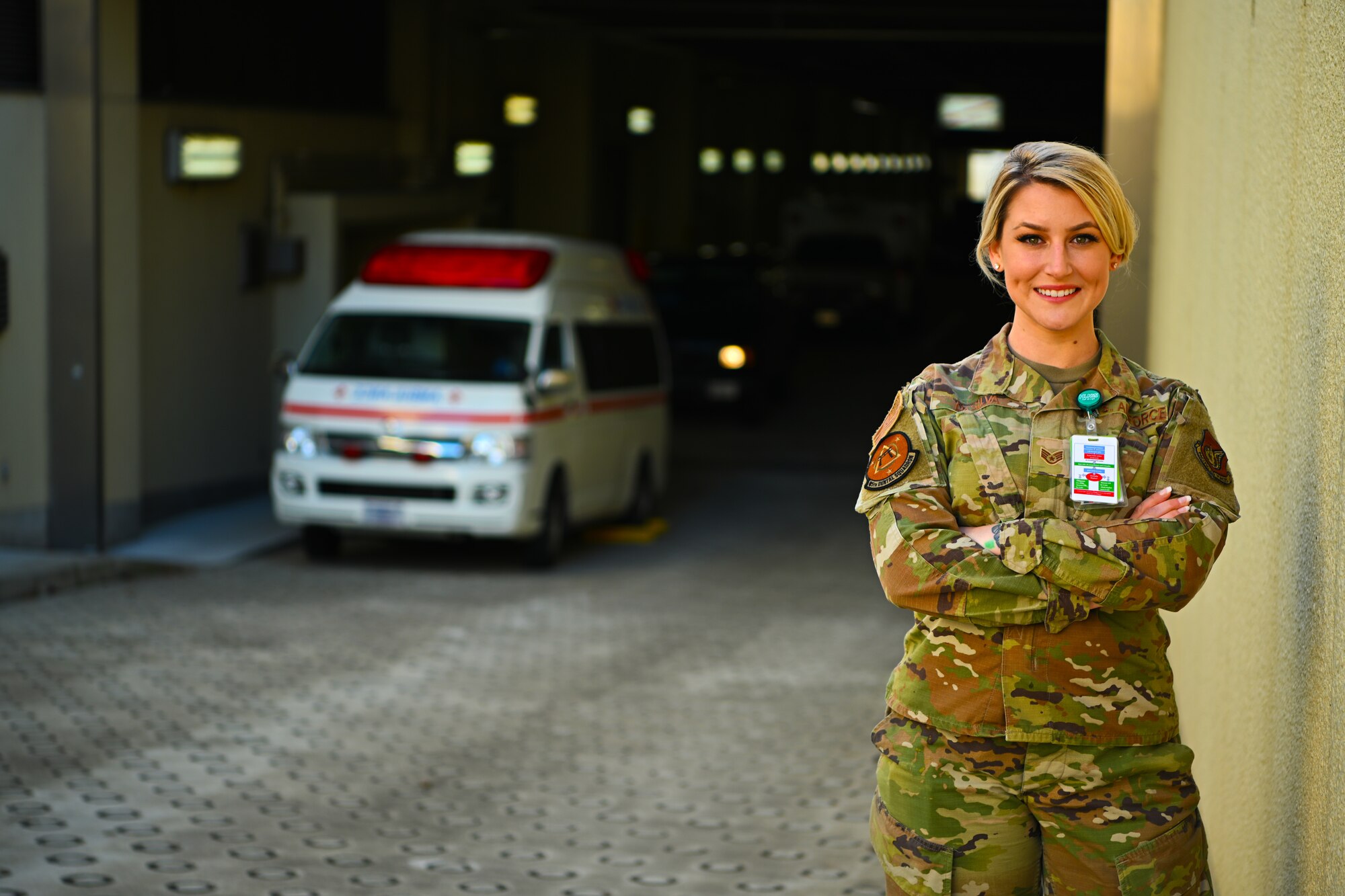 A female poses for a photo near the urgent care tunnel at the 35th Medical Group.