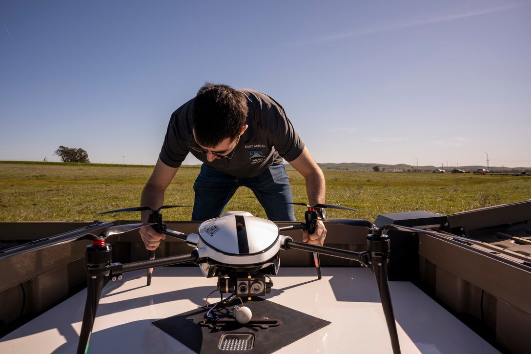A man inspects a drone.