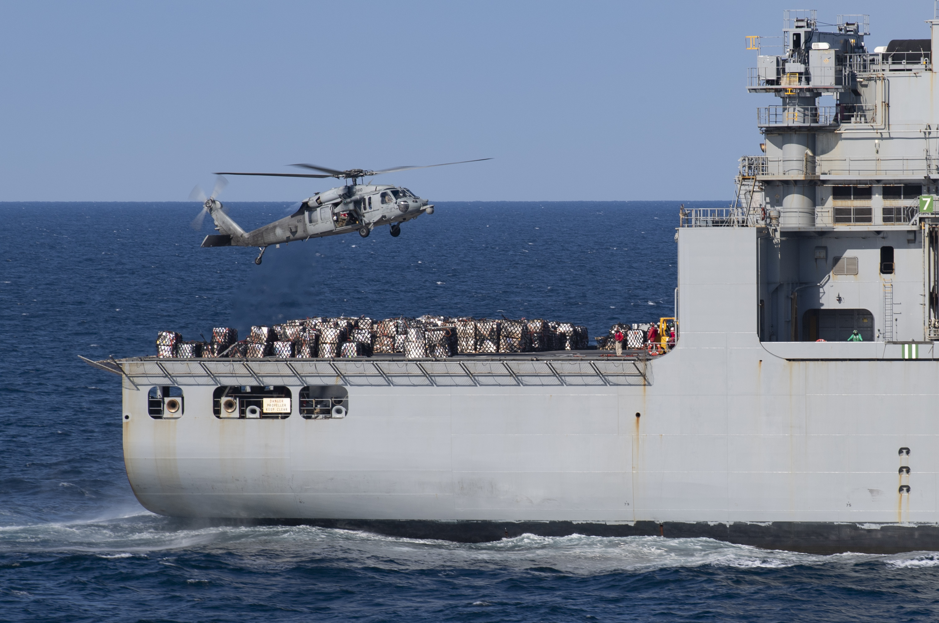 USNS Matthew Perry (T-AKE-9) steams alongside USS Nimitz (CVN 68) during a replenishment-at-sea.