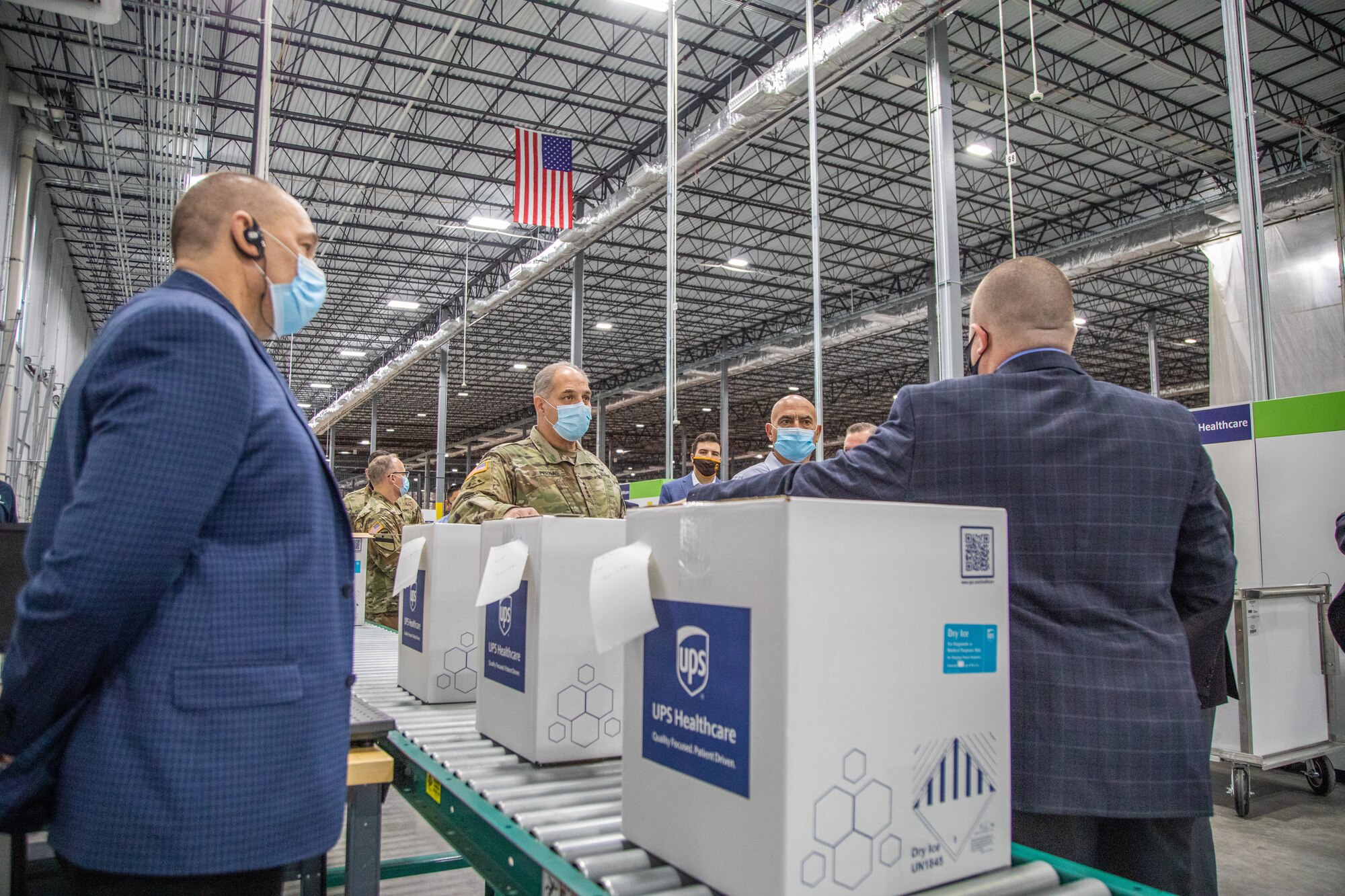 Two men are given a tour of a freezer farm.