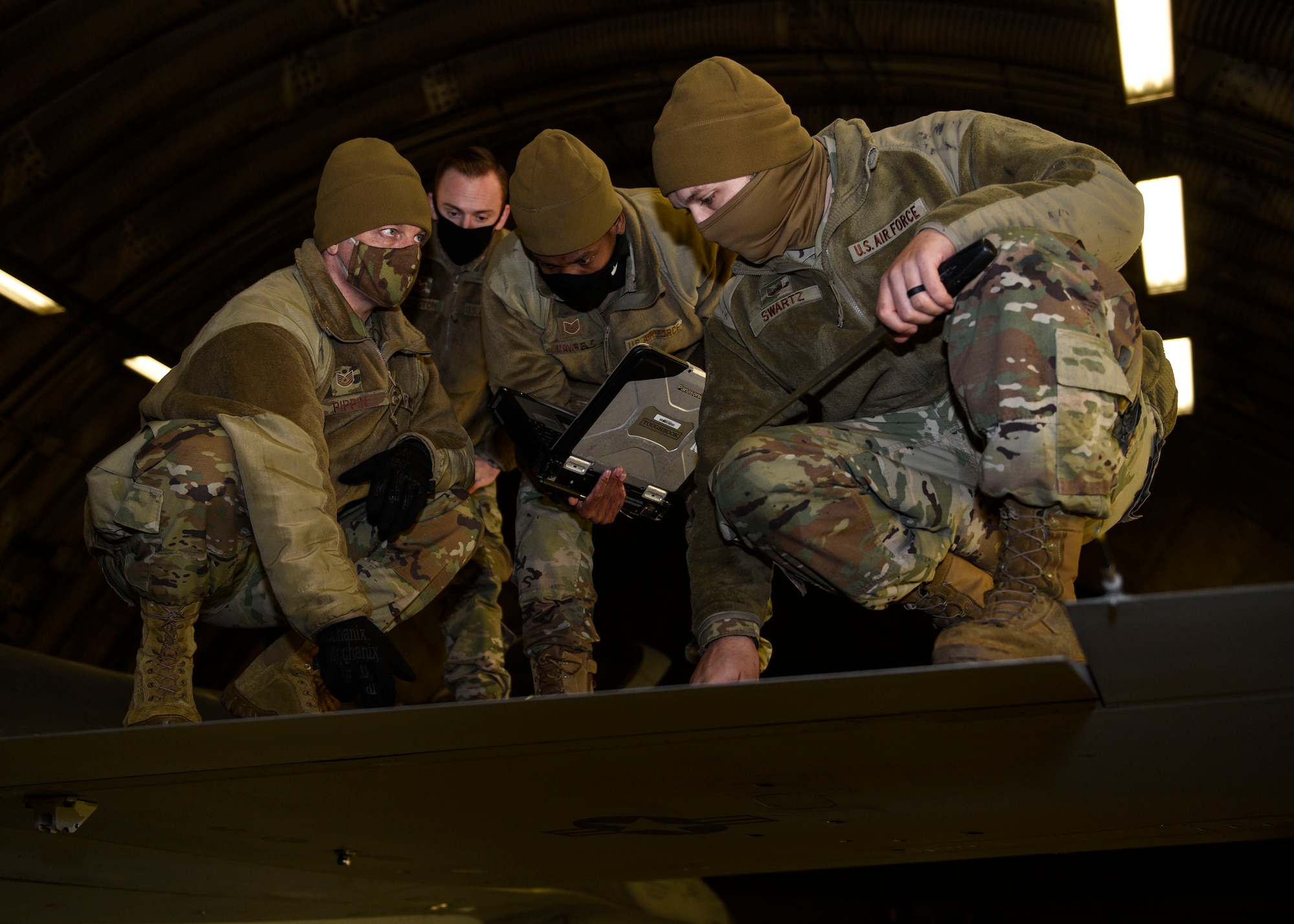 From far left, U.S. Air Force Tech Sgt. Bradley Pippin, 52nd Maintenance Group maintenance training instructor, Staff Sgt. Joseph Livingston, 52nd MXG maintenance training instructor, Tech Sgt. Jeremy Mayfield, 52nd Maintenance Squadron engine technician, and Tech Sgt. Alec Swartz, 52nd Aircraft Maintenance Squadron avionics specialist, perform an inspection on the wing of an F-16 Fighting Falcon, Dec. 9, 2020, at Spangdahlem Air Base, Germany. The inspection was part of an Agile Combat Employment course, which enables Airmen to become more versatile outside of their respective career fields and allow aircraft to increase deterrence capabilities in more remote locations. (U.S. Air Force photo by Senior Airman Melody W. Howley)