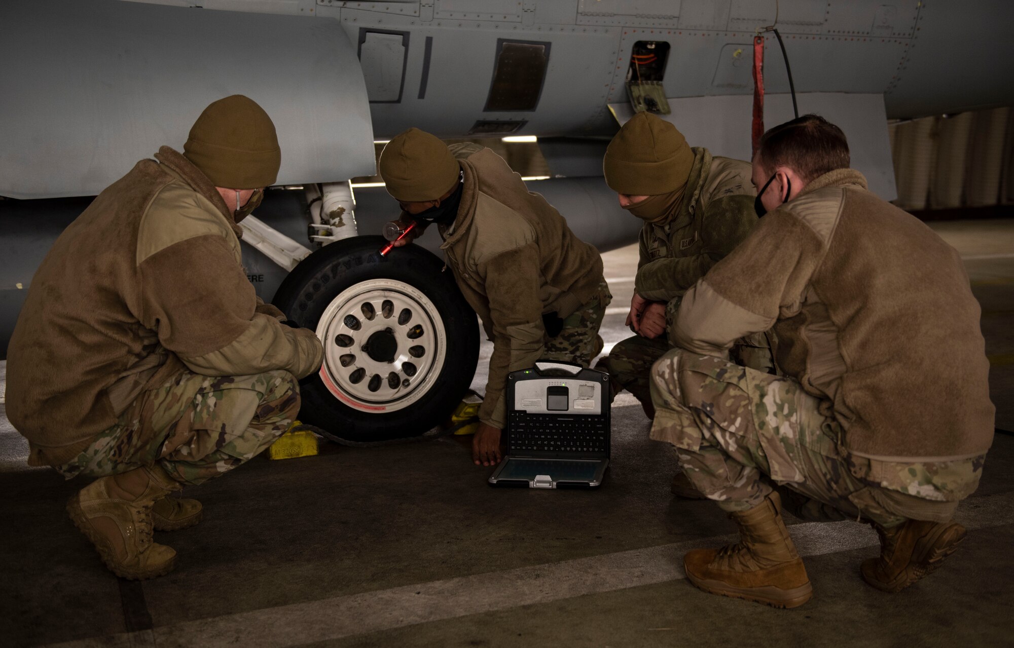 From far left, U.S. Air Force Tech Sgt. Bradley Pippin, 52nd Maintenance Group maintenance training instructor, Tech Sgt. Jeremy Mayfield, 52nd Maintenance Squadron engine technician, Tech Sgt. Alec Swartz, 52nd Aircraft Maintenance Squadron avionics specialist, and Staff Sgt. Joseph Livingston, 52nd MXG maintenance training instructor, perform a pre-flight inspection, Dec. 9, 2020, at Spangdahlem Air Base, Germany. During the inspection, the students were ensuring that the aircraft was ready to fly with no complications and that it was fully serviceable. (U.S. Air Force photo by Senior Airman Melody W. Howley)