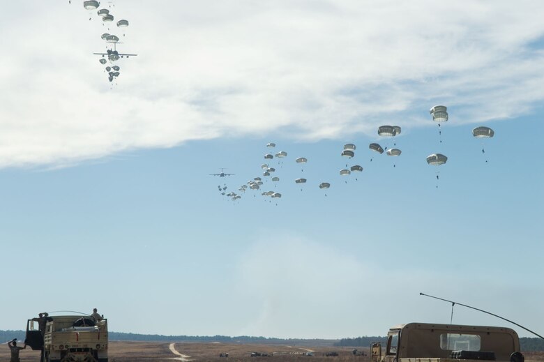 Paratroopers from the U.S. Army’s 82nd Airborne Division jump from C-130s during a Battalion Mass Tactical Week training at Pope Army Airfield, N.C., Dec. 10, 2020.