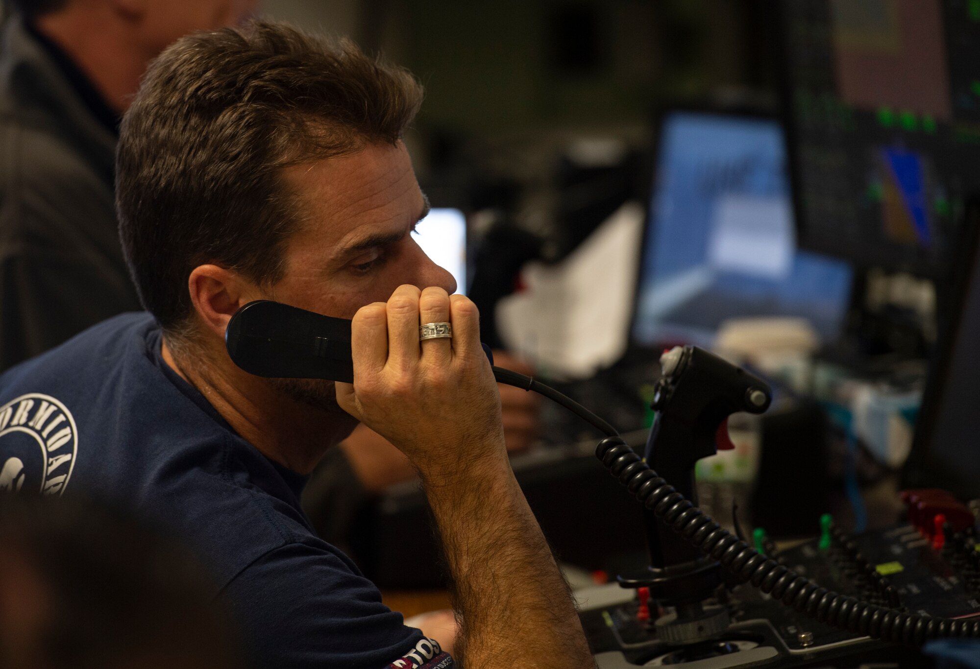 A remote control operator speaks into a radio at the Yuma Proving Grounds, Ariz. Dec 9, 2020. The RTO controlled ax XQ-58A Valkerie during a test flight. (U.S. Air Force photo by Staff Sgt. Joshua King)