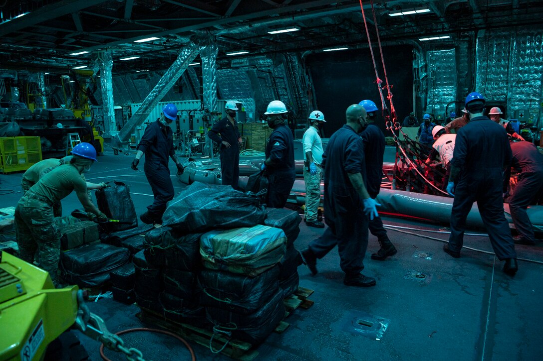 USS Gabrielle Giffords (LCS 10) and embarked U.S. Coast Guard Law Enforcement Detachment (LEDET) 407 offload suspected contraband while conducting enhanced counter-narcotics operations, Dec. 5, 2020.
