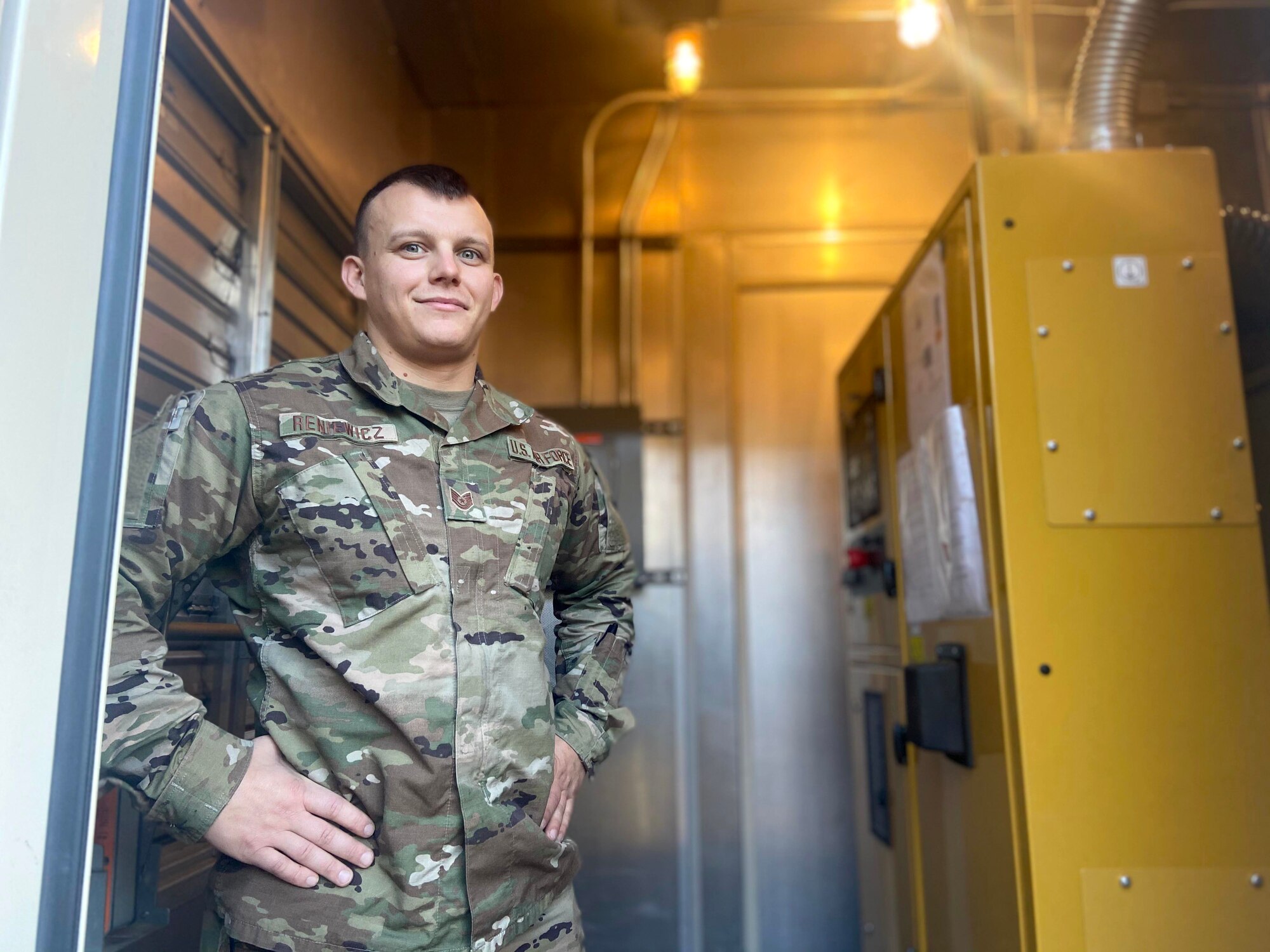 Tech. Sgt. Michael Reniewicz, 104th Fighter Wing power production shop leader, stands alongside base generators on December 10, 2020 at Barnes Air National Guard Base. The testing he is about to perform ensures power reliability in the event of a commercial loss of power. (U.S. Air National Guard Photo by Airman 1st Class Camille Lienau)