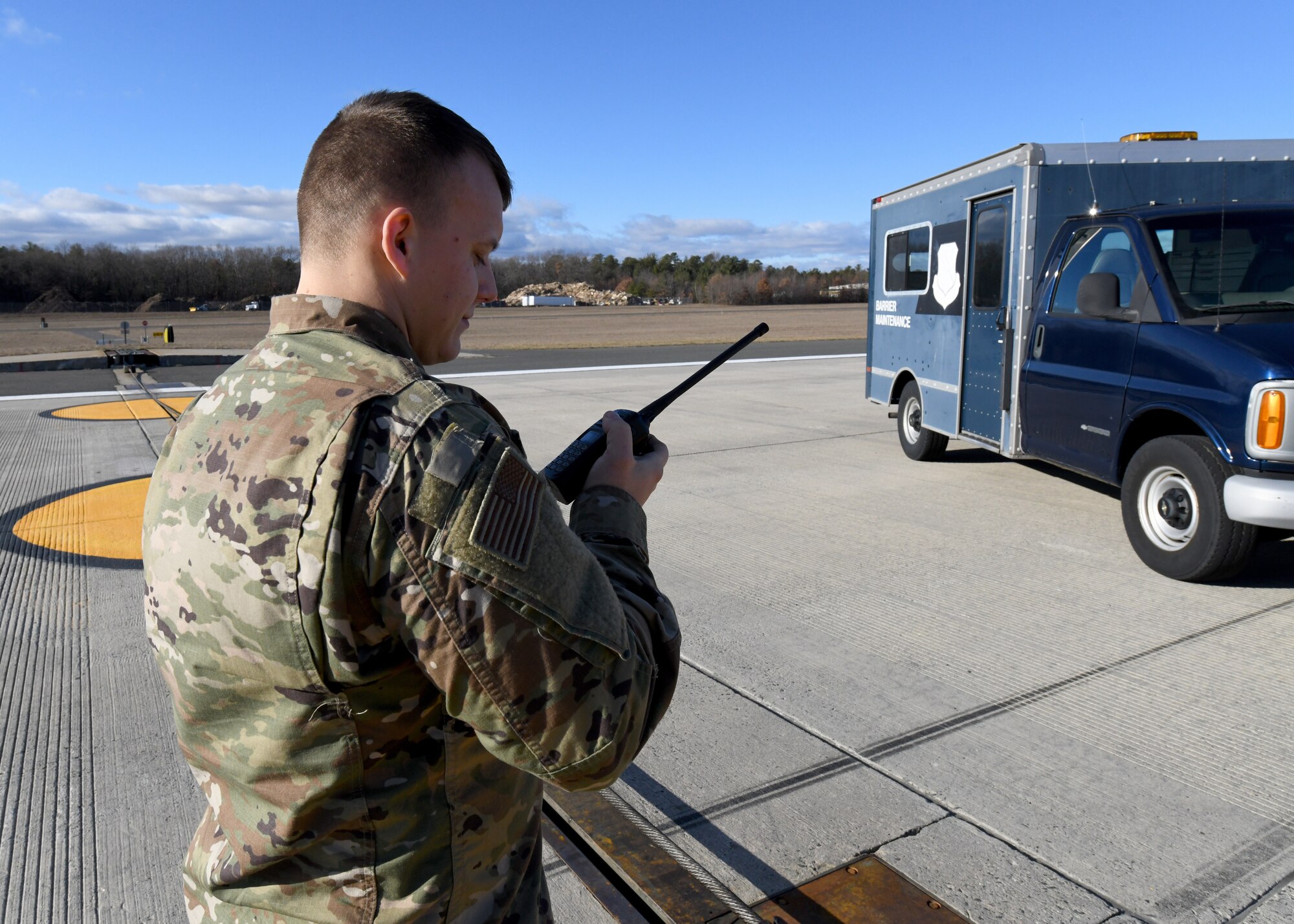 Tech. Sgt. Michael Reniewicz, 104th Fighter Wing power production shop leader, speaks with the control tower to lower the arresting cables at Barnes Air National Guard Base December 10, 2020. The arresting cables safely catch aircraft in the event of an engine malfunction or rejected takeoff. (U.S. Air National Guard Photo by Airman 1st Class Camille Lienau)