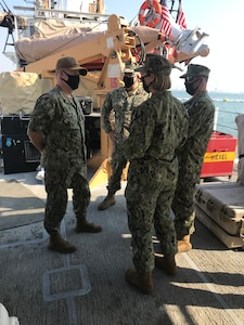 From left to right, Vice. Adm. Samuel Paparo, commander of U.S. Naval Forces Central Command (NAVCENT), U.S. 5th Fleet and Combined Maritime Forces (CMF), speaks with Lt. Ben Williamsz, commanding officer of the U.S. Coast Guard patrol boat USCGC Adak (WPB 1333), Lt. j.g. Jillian Bray and Chief Machinery Technician Shaun Garret, during a tour of the ship, Dec. 14. PATFORSWA is comprised of the Maritime Engagement Team, shoreside support personnel and six 110' cutters and is the Coast Guard's largest unit outside of the U.S., playing a key role in supporting the Navy’s maritime security and maritime infrastructure protection operations in the U.S. 5th Fleet area of operations.