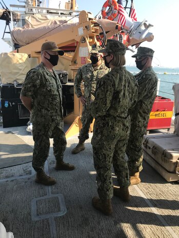 From left to right, Vice. Adm. Samuel Paparo, commander of U.S. Naval Forces Central Command (NAVCENT), U.S. 5th Fleet and Combined Maritime Forces (CMF), speaks with Lt. Ben Williamsz, commanding officer of the U.S. Coast Guard patrol boat USCGC Adak (WPB 1333), Lt. j.g. Jillian Bray and Chief Machinery Technician Shaun Garret, during a tour of the ship, Dec. 14. PATFORSWA is comprised of the Maritime Engagement Team, shoreside support personnel and six 110' cutters and is the Coast Guard's largest unit outside of the U.S., playing a key role in supporting the Navy’s maritime security and maritime infrastructure protection operations in the U.S. 5th Fleet area of operations.