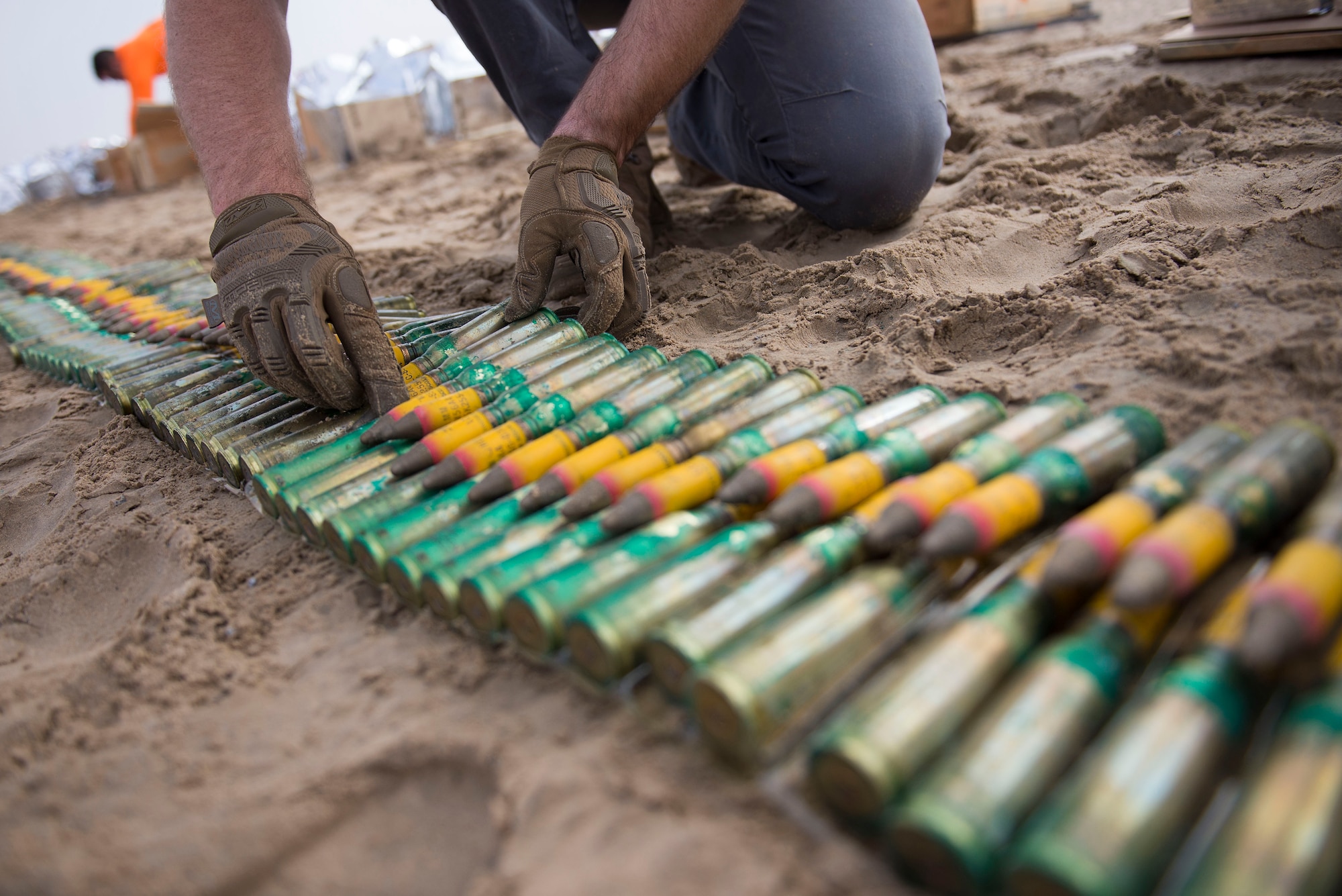 A U.S. Airman assigned to the 380th Expeditionary Civil Engineer Squadron (ECES) Explosive Ordnance Disposal (EOD) flight arranges munitions to be safely disposed of as part of an ammunitions disposition request (ADR) near Al Dhafra Air Base, United Arab Emirates, Dec. 5, 2020.