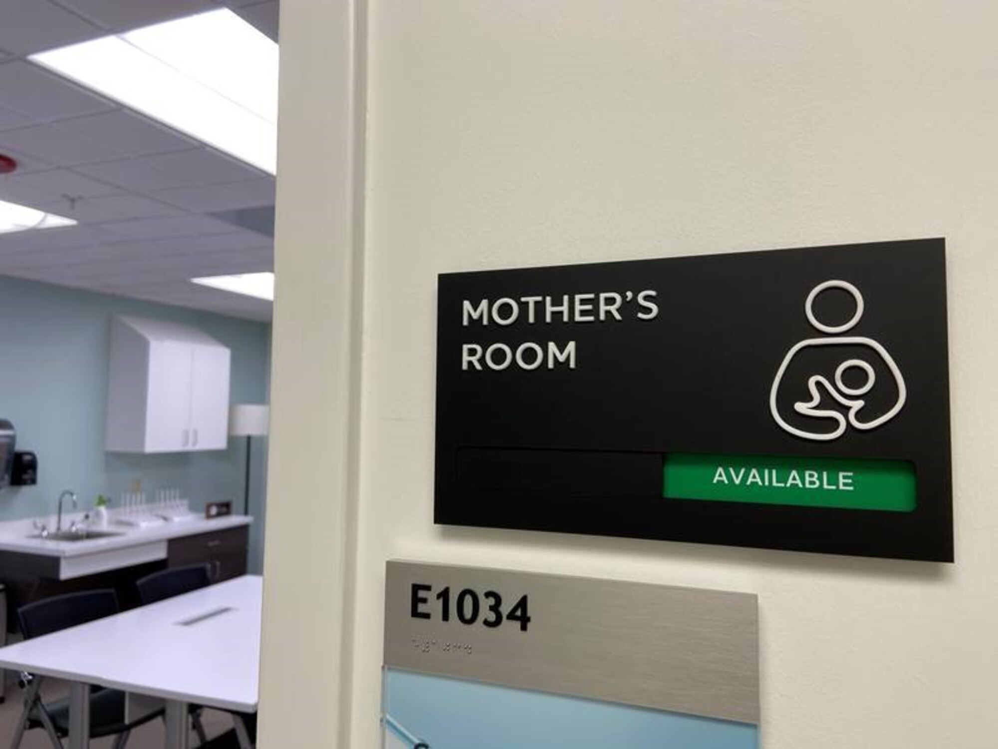 Photo shows the sign to a "Mother's Room."