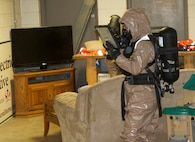 Sgt. Karlee Jones takes pictures of a room