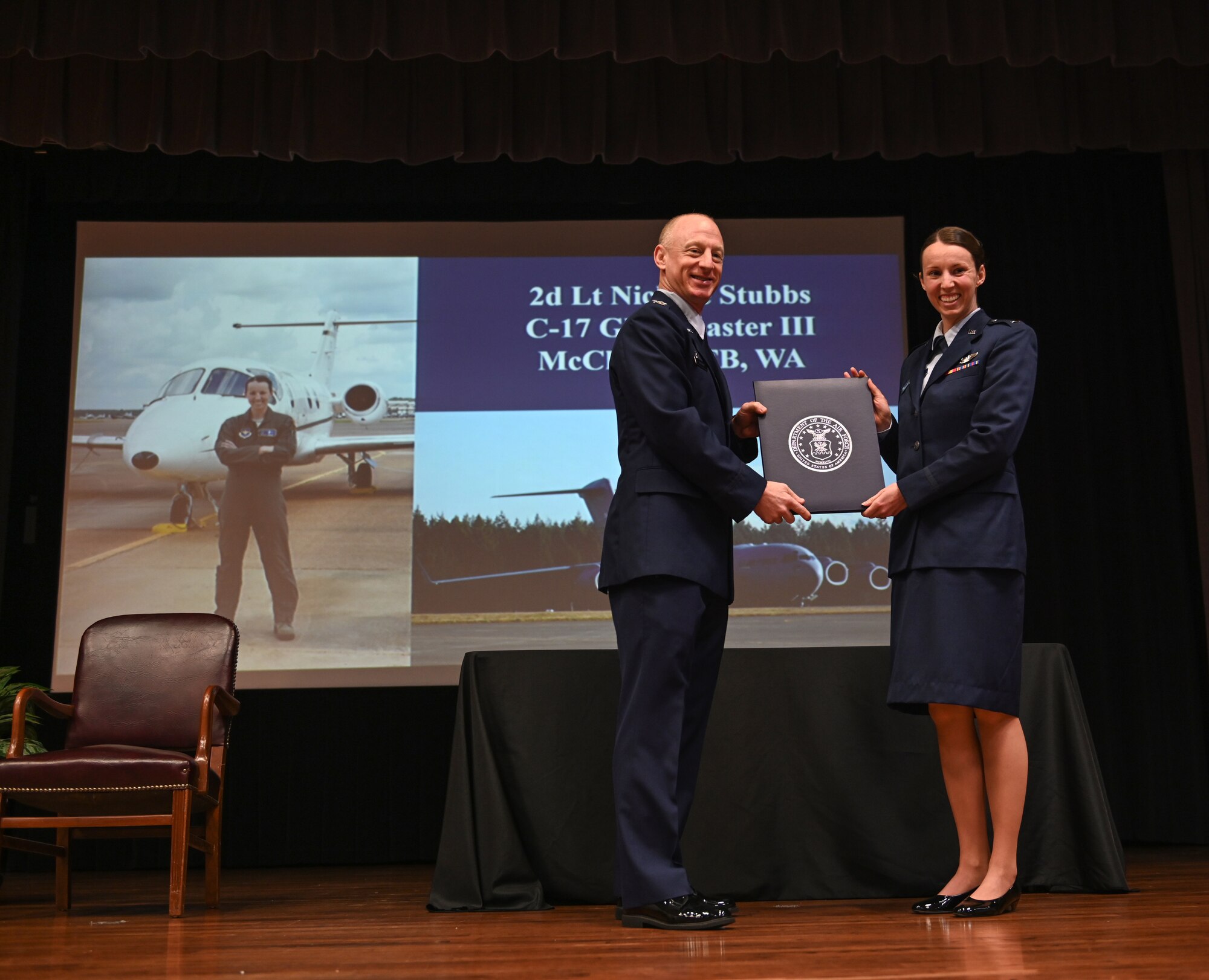 U.S. Air Force Col. Seth Graham, 14th Flying Training Wing commander, stands with 2nd Lt. Nicole Stubbs, Specialized Undergraduate Pilot Training graduate, on Dec. 11, 2020, at Columbus Air Force Base, Miss. Stubbs was assigned to fly the C-17 Globemaster III at McChord Air Force Base, Wash. (U.S. Air Force photo by Airman 1st Class Davis Donaldson)