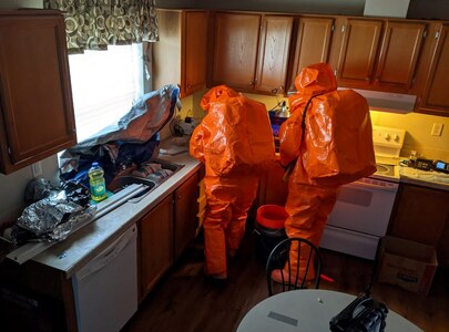Sgt Matt Giddens and Staff Sgt. Dustin Foreman inspects a biological agent in the kitchen of an abandoned house