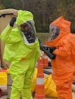 Sgt. First Class Zachary Davenport decontaminates Staff Sgt. Justin Doherty