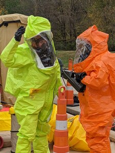 Sgt. First Class Zachary Davenport decontaminates Staff Sgt. Justin Doherty