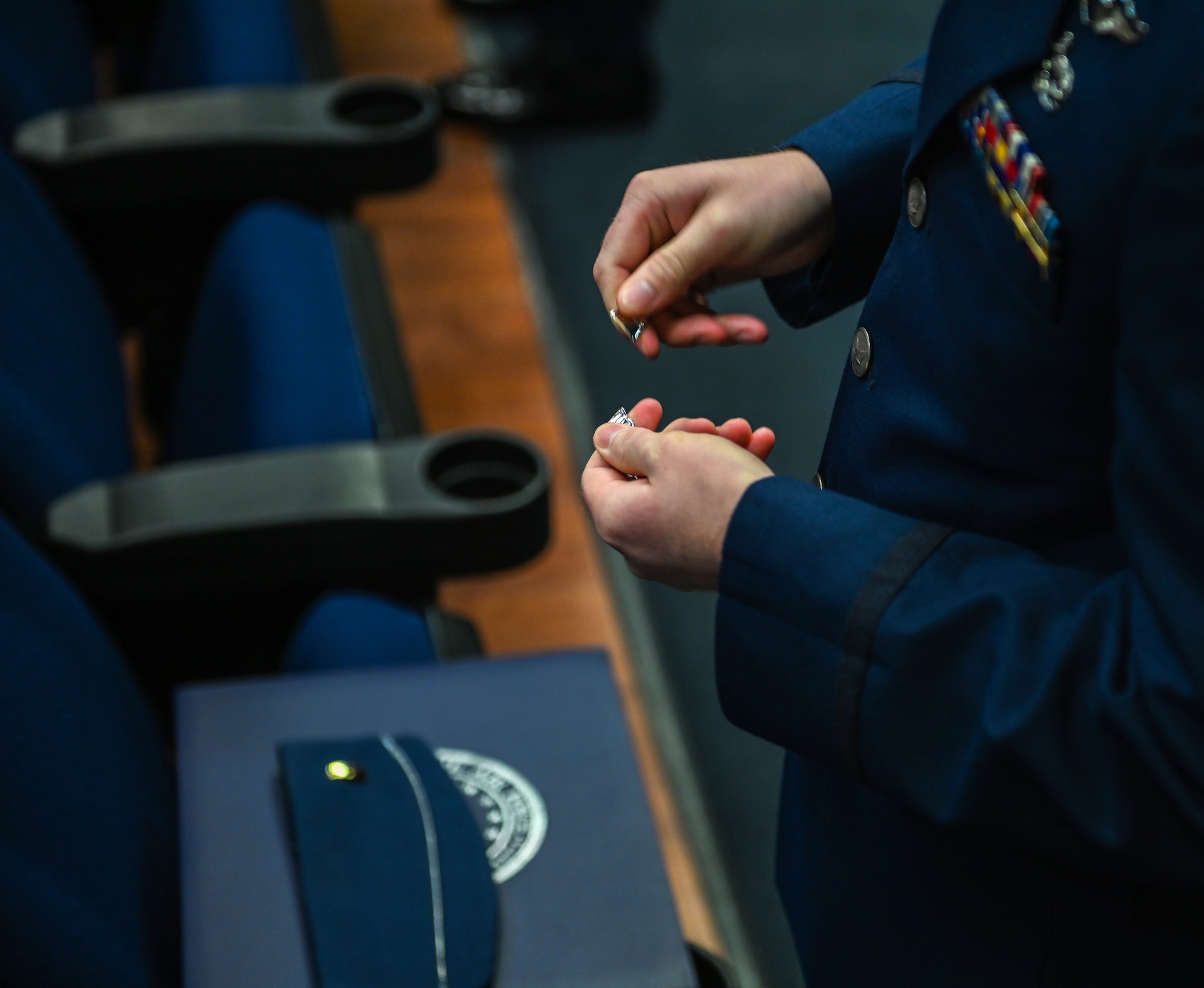 A graduate from Specialized Undergraduate Pilot Training Class 21-03 breaks his “silver wings” in half on Dec. 11, 2020, at Columbus Air Force Base, Miss. As tradition, pilots will break their first pair of wings to keep one half and give the other half to a loved one. (U.S. Air Force photo by Airman 1st Class Davis Donaldson)