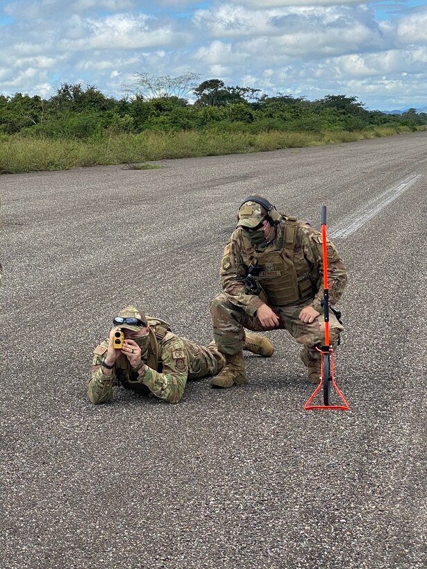 U.S. Air Force Master Sgt. Bryan Masters, 621st Contingency Response Squadron airfield manager, left, and U.S. Air Force Tech. Sgt. Luis Barrios, 621st CRS airfield manager, perform a C-130 Hercules aircraft suitability check to assess the ability of the aircraft to safely land at Aguacate landing zone in Catacamas, Honduras, Nov. 24, 2020. An airfield assessment team conducts detailed airfield surveys and are comprised of eight Air Force specialty codes including civil engineer, airfield management, fuels, air transportation, contracting and security forces. (U.S. Air Force photo)