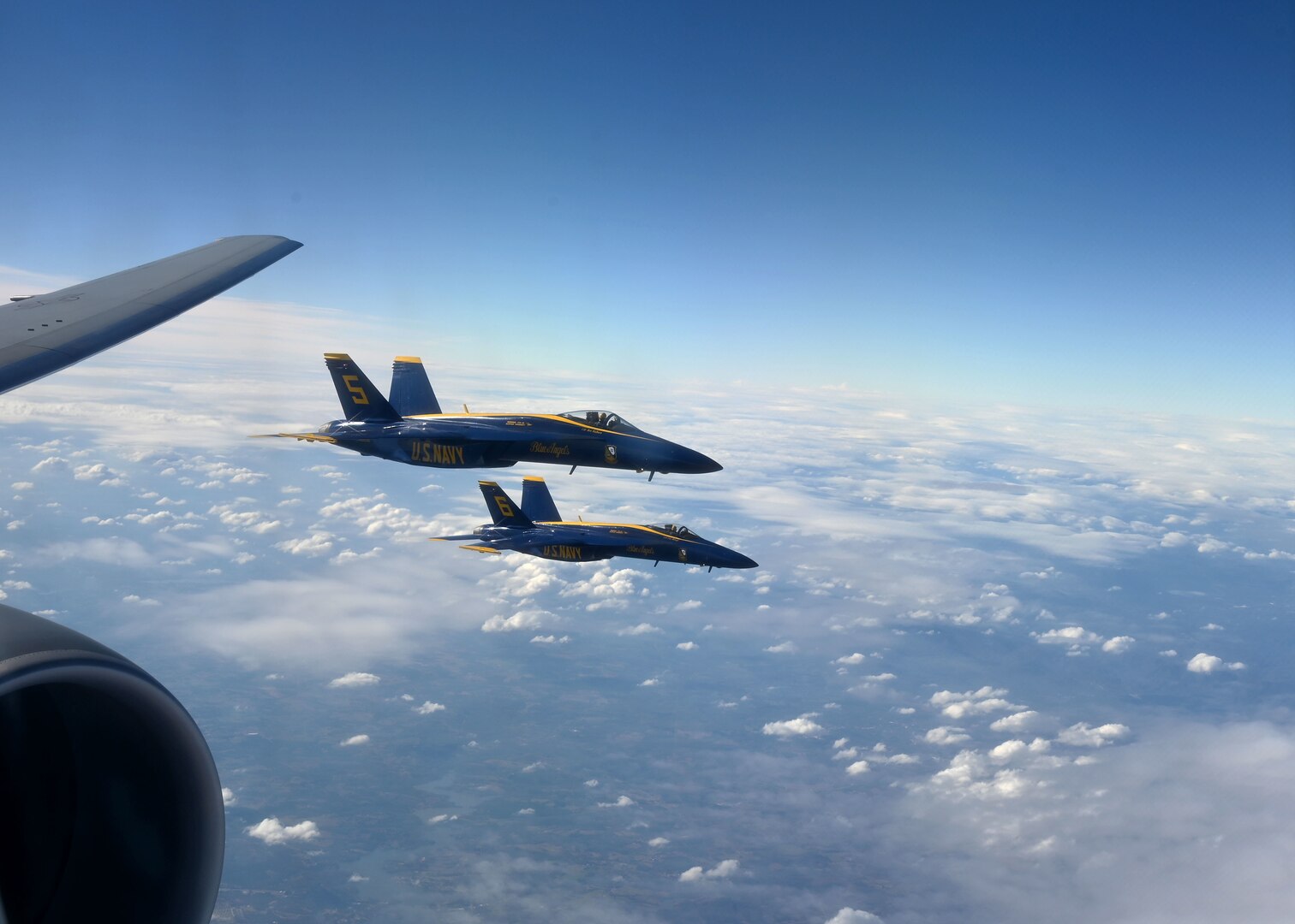 Two F/A-18 Super Hornets of the U.S. Navy's Blue Angels flight squadron fly alongside a Pease KC-46A Pegasus refueler Dec. 12, 2020, in Georgia airspace. The jets were refueled for a flyover at the Army-Navy Game in West Point, N.Y. The Pease aircrew teamed with another KC-46A from McConnell AFB, Kan.
